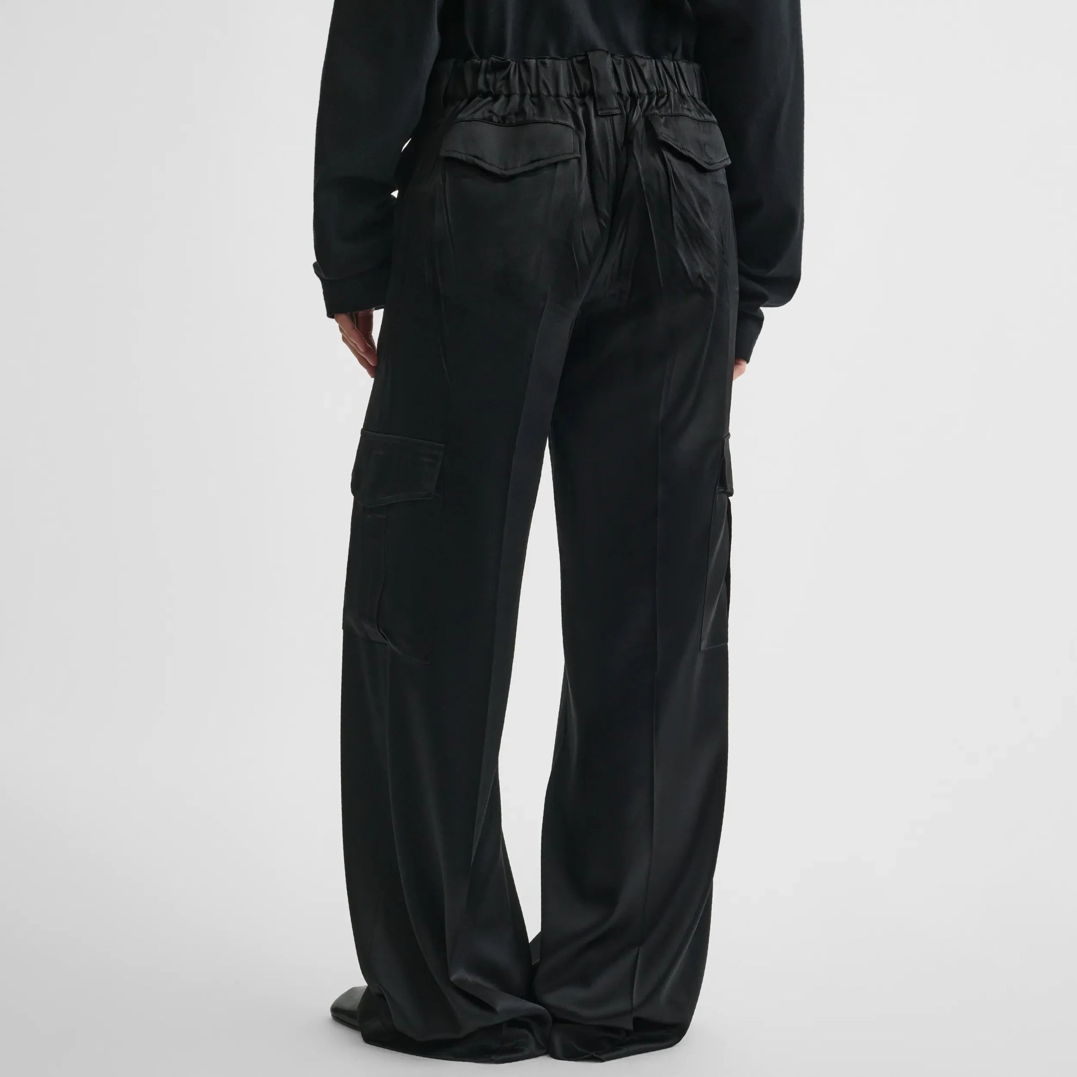 Back view of liquid cargo trousers in black silk