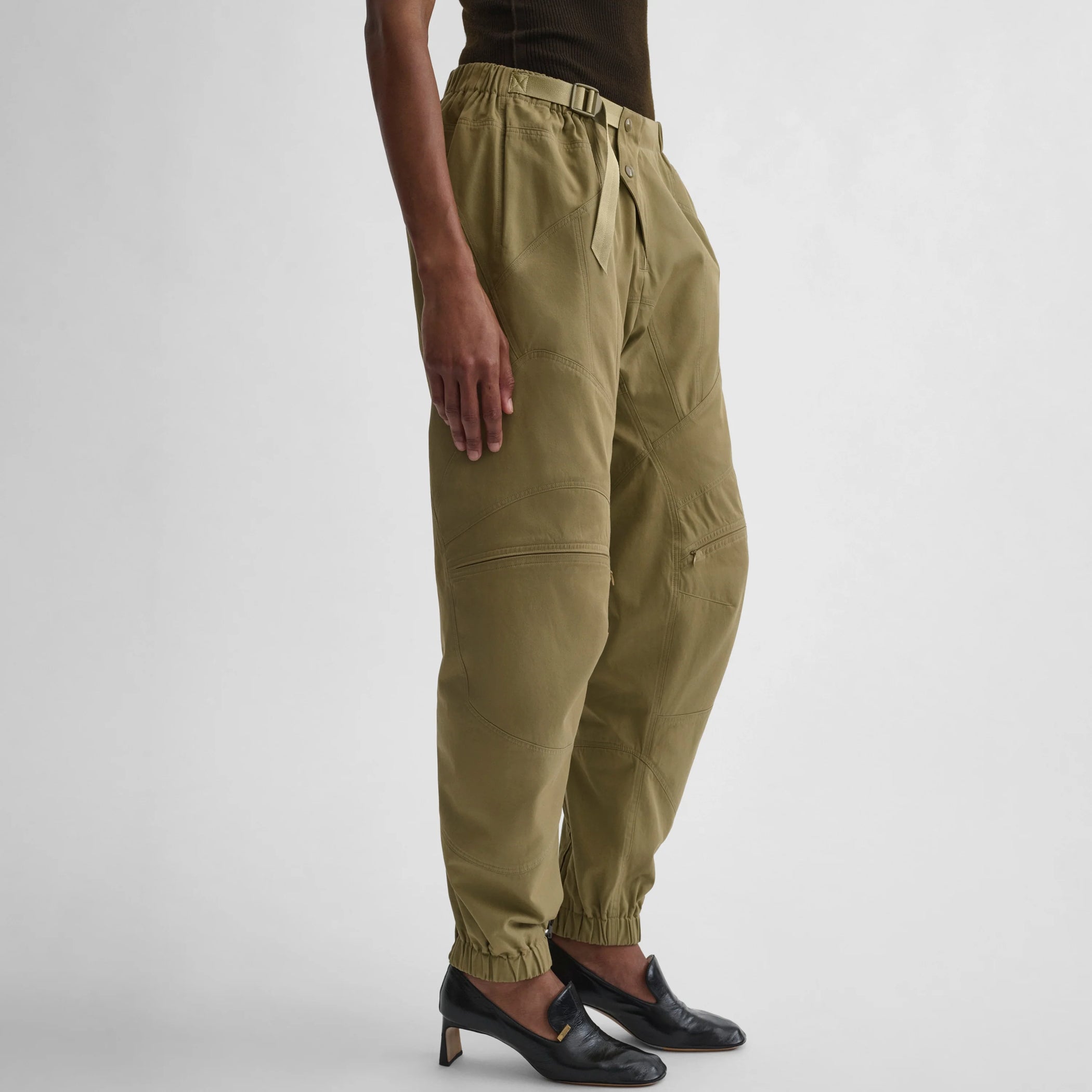 Angled view of the model wearing the BMX trousers in sage