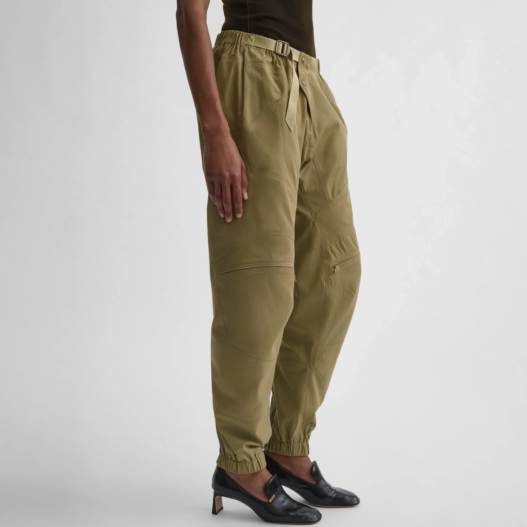 Angled view of the model wearing the BMX trousers in sage