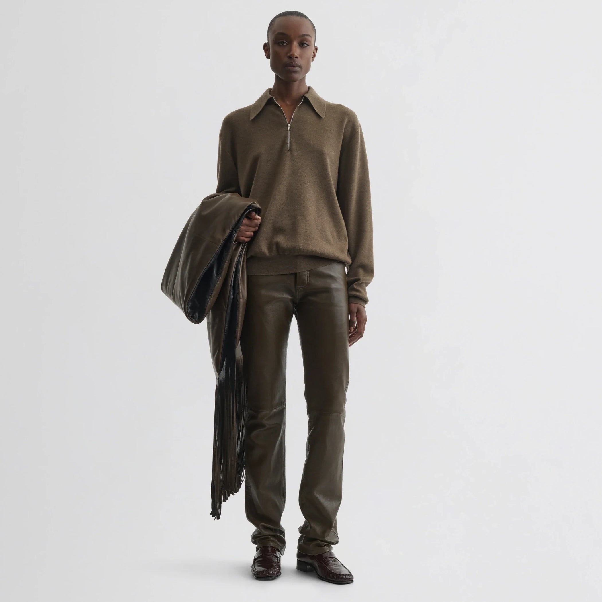Front view of model wearing straight leg jeans in green bronze leather.