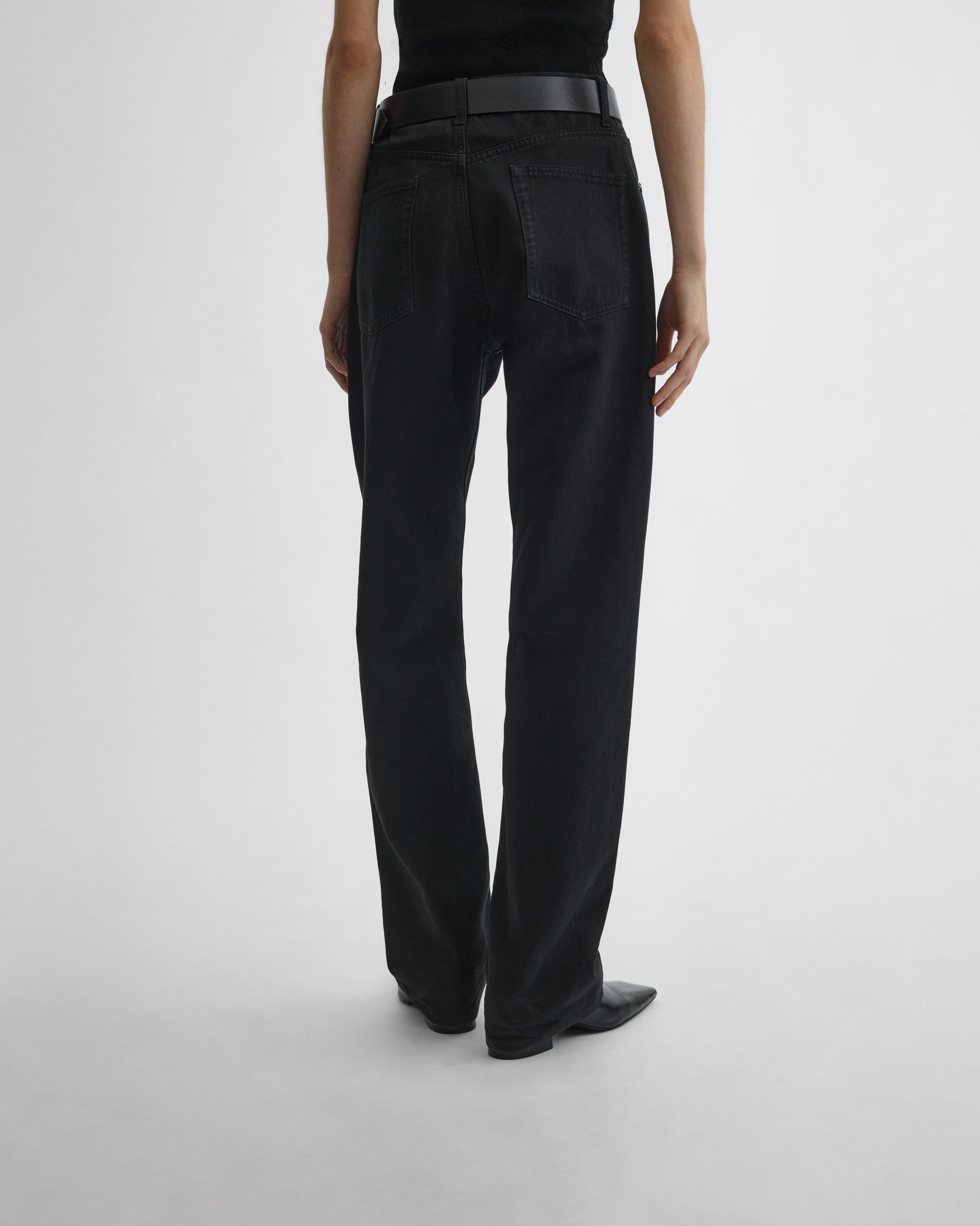 Back view of model wearing CLASSIC JEANS in black cotton