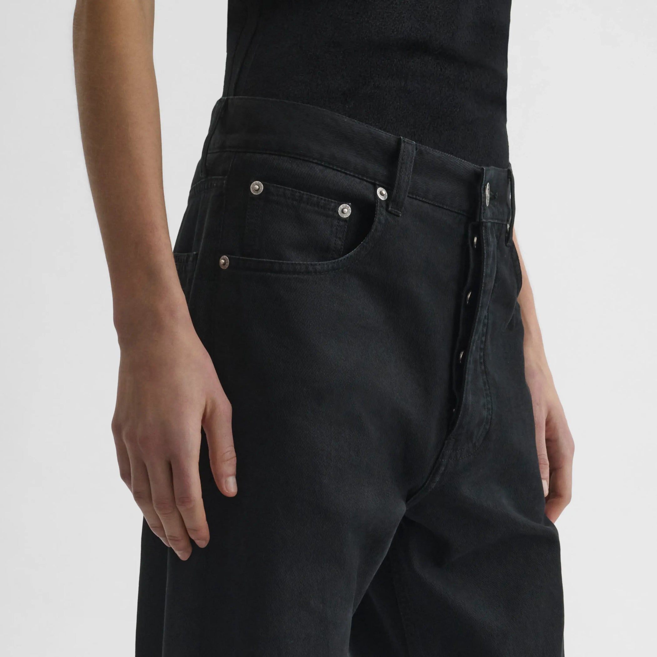 Detailed view of model wearing Classic Jeans in black.