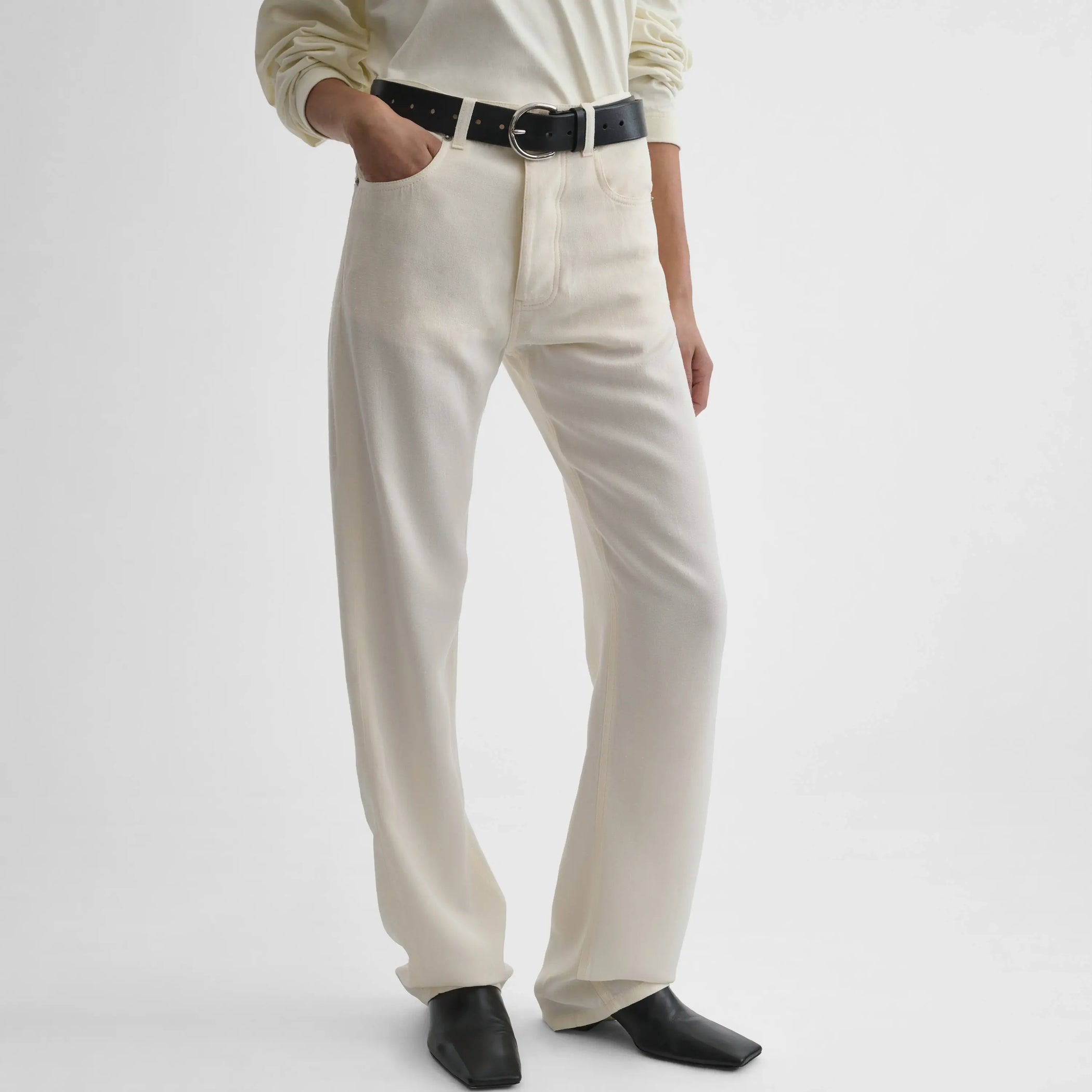 Front view of model wearing Classic Jeans in off white.