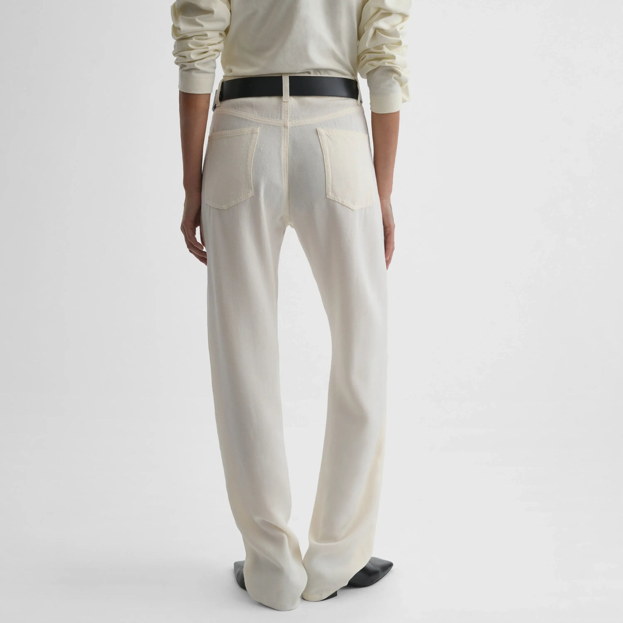 Back view of model wearing Classic Jeans in off white.