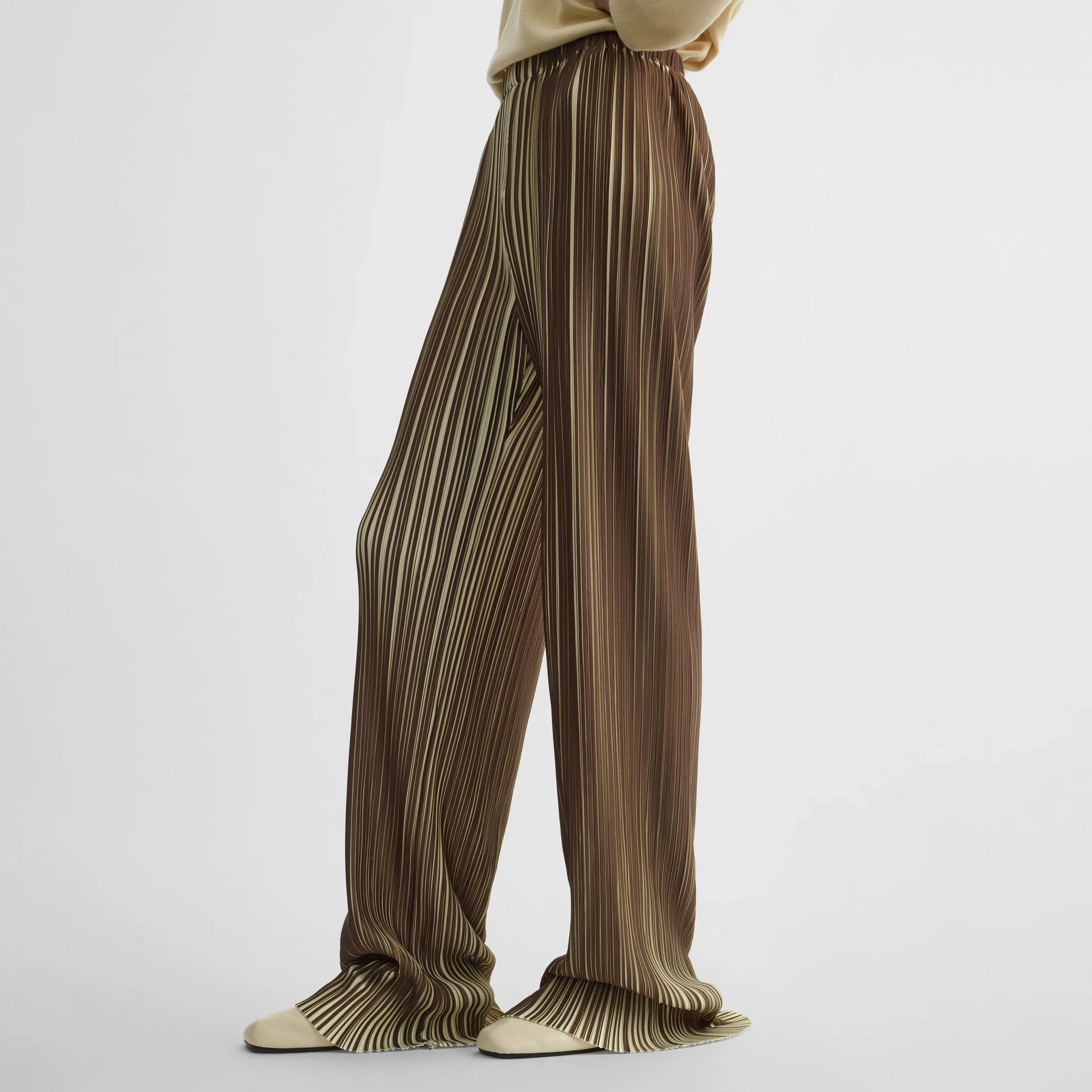 Side view of model wearing razor pleat trousers in khaki polyester.