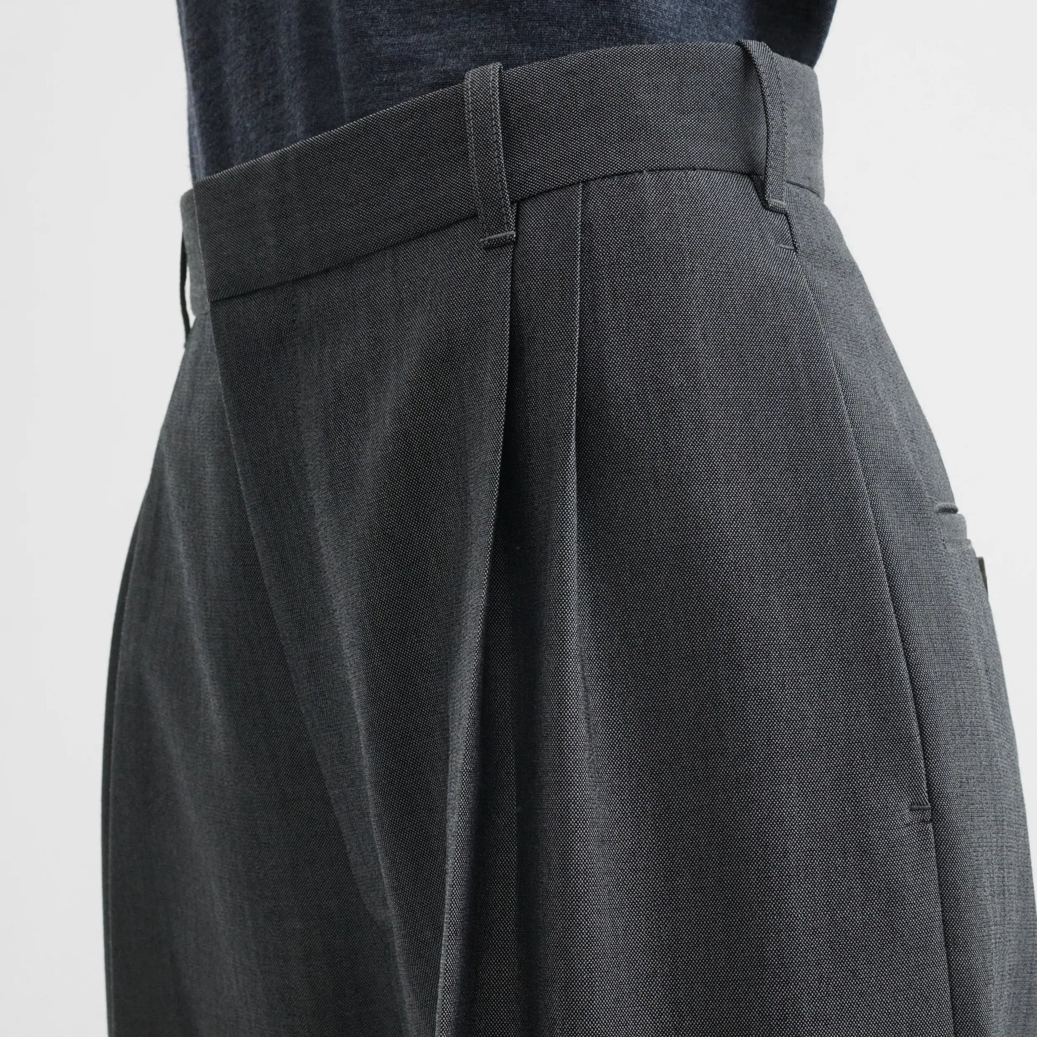 Close up detail view of double pleat trousers in grey-melange wool