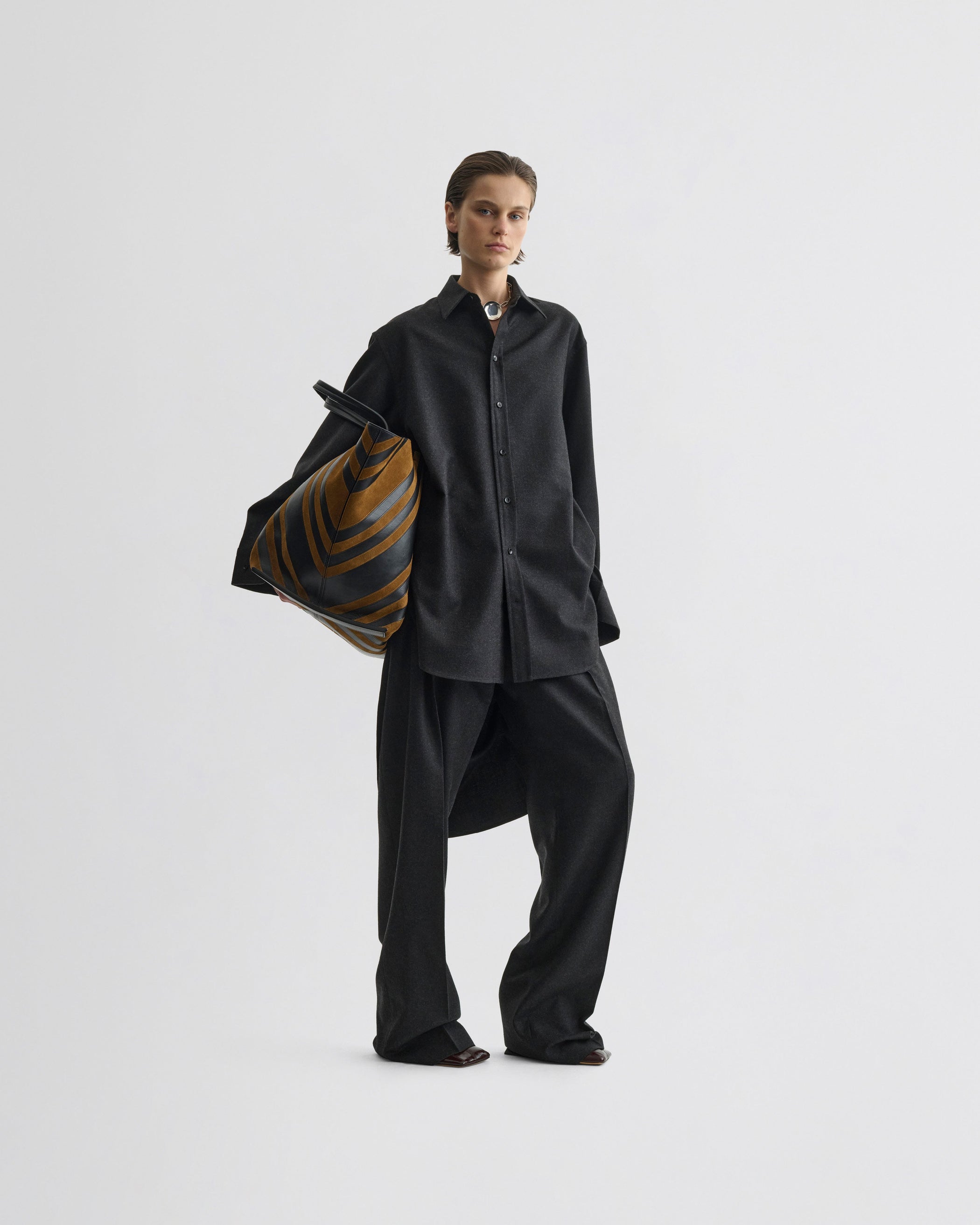 View of double pleat trousers in charcoal wool