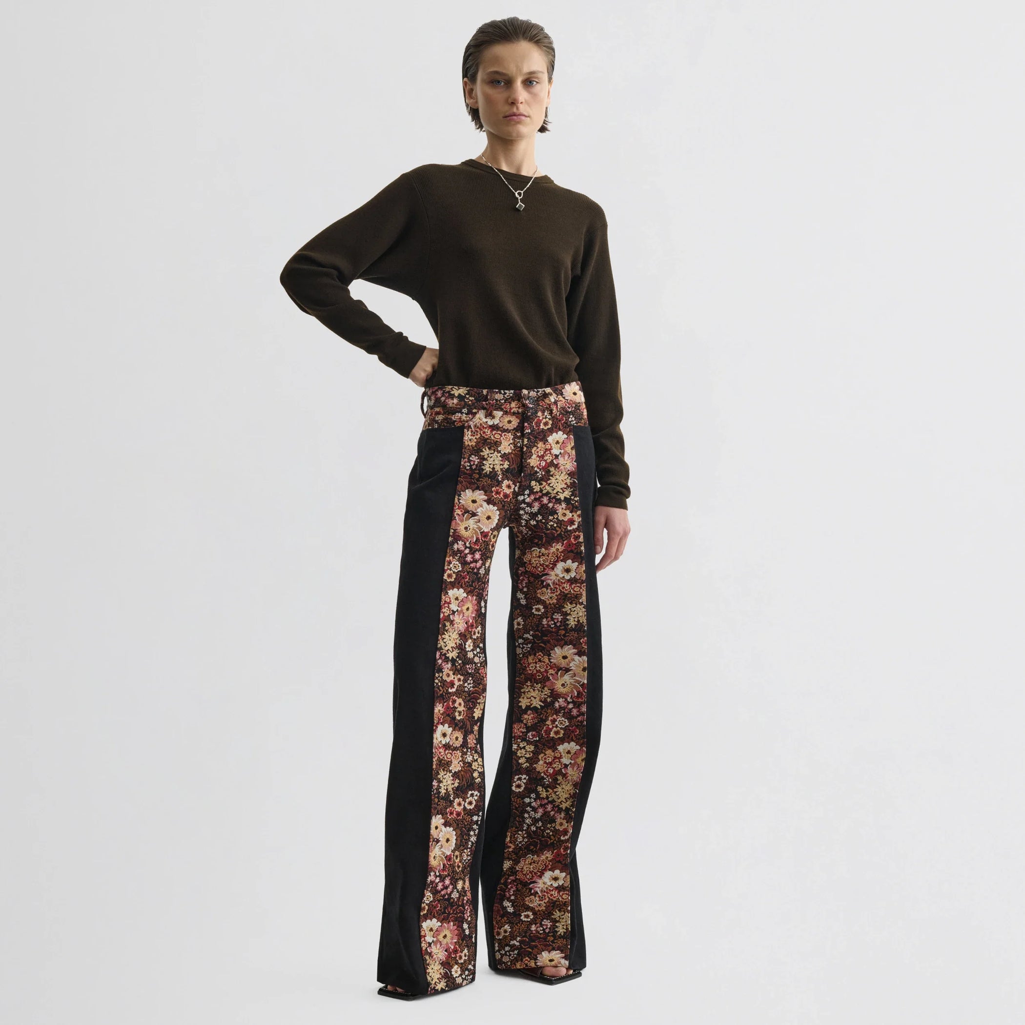 Front view of model wearing tapestry trousers in black cotton.