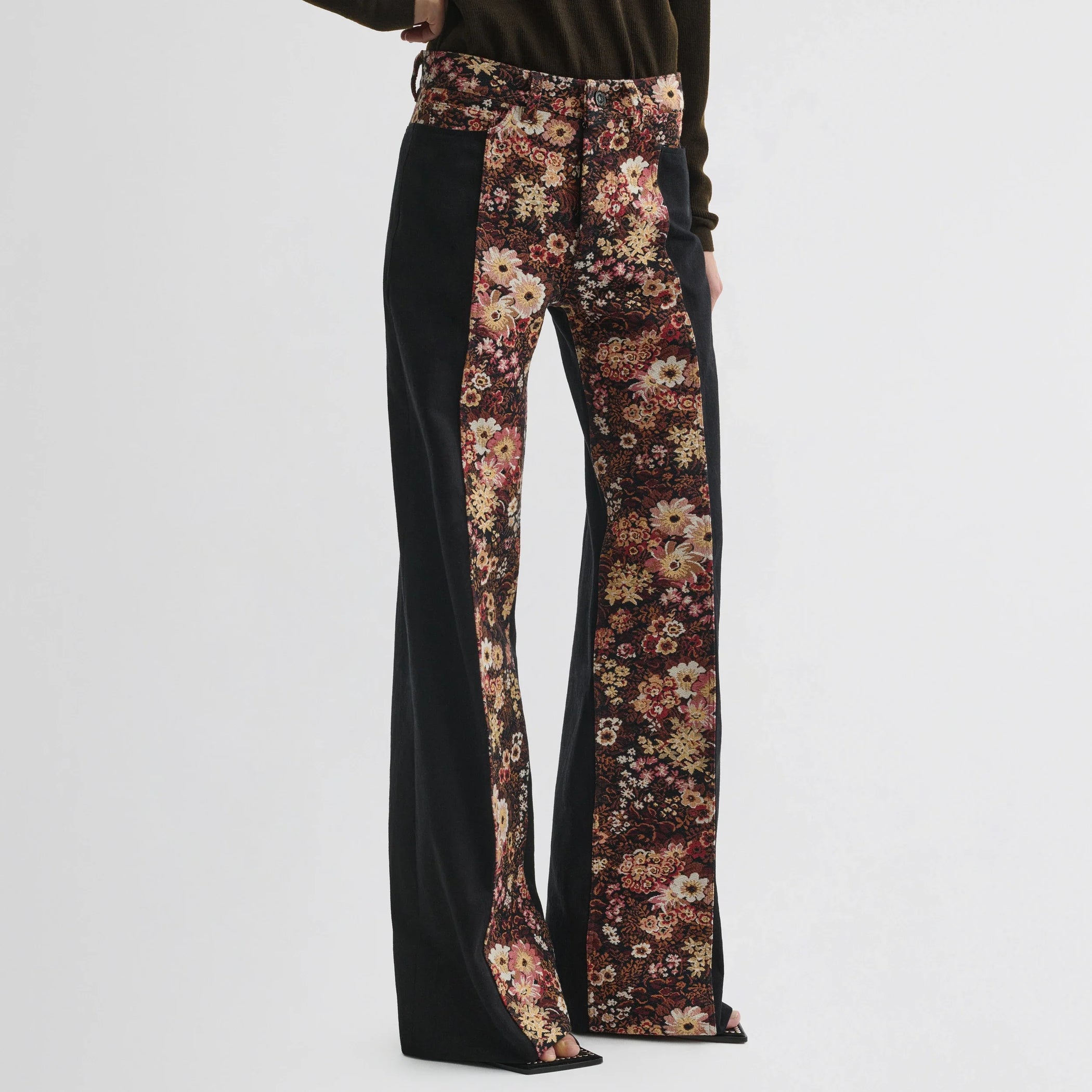 Front view of model wearing tapestry trousers in black cotton.