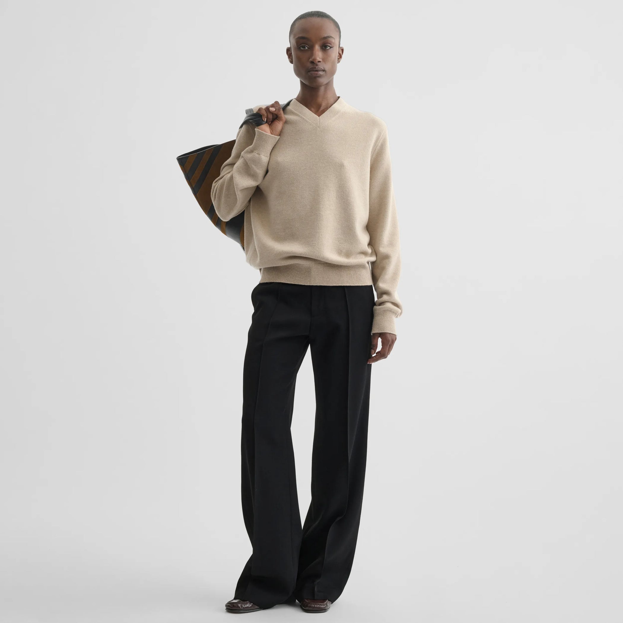 Front view of boyish tailored trousers in black wool