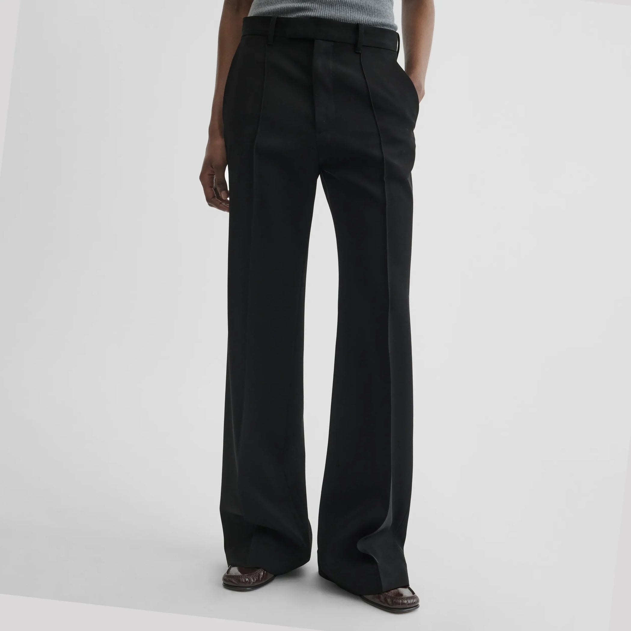 Front view of boyish tailored trousers in black wool
