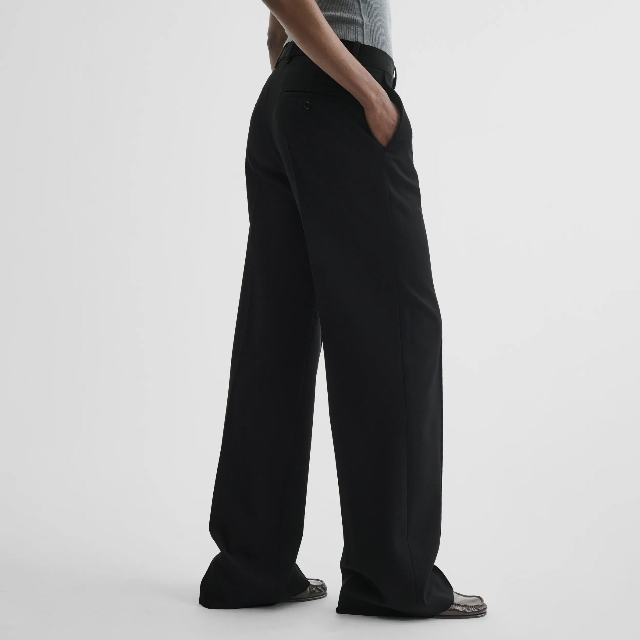 Side view of boyish tailored trousers in black wool