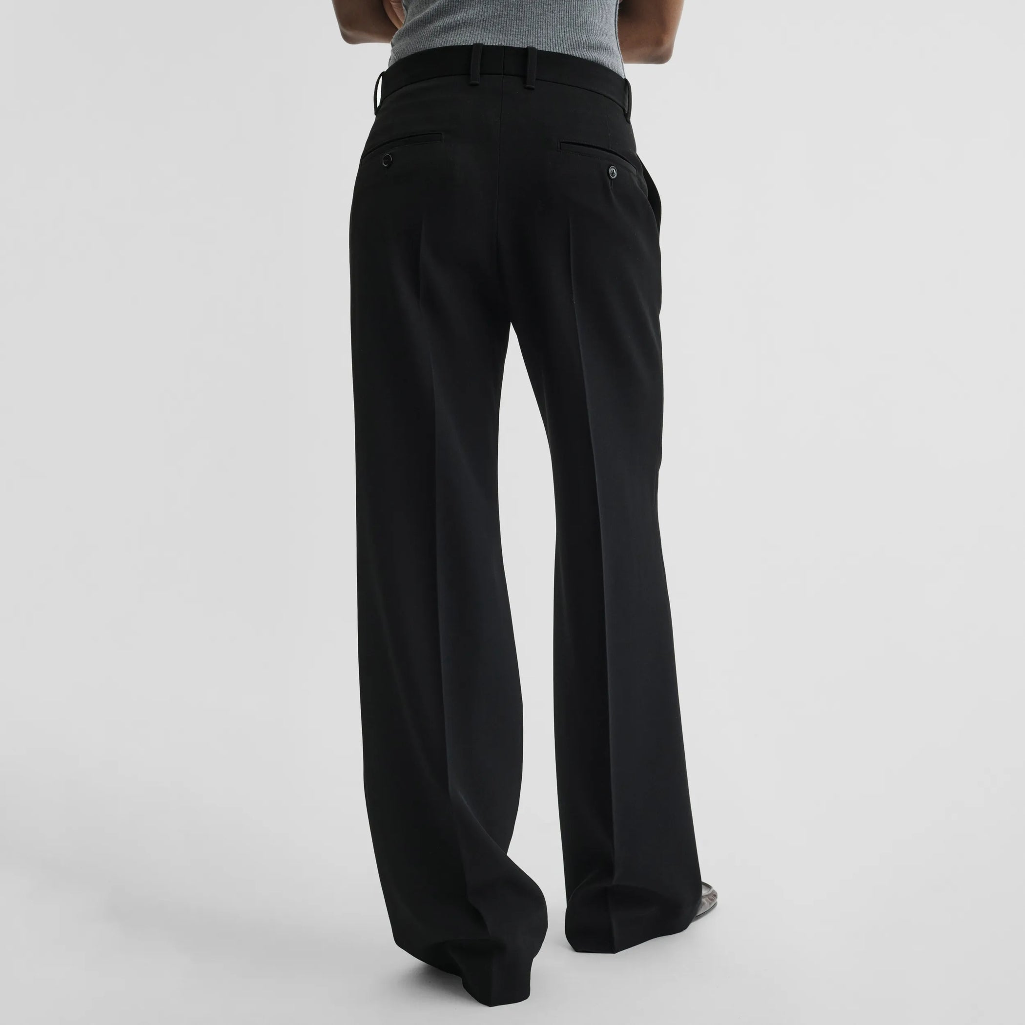 Back view of boyish tailored trousers in black wool
