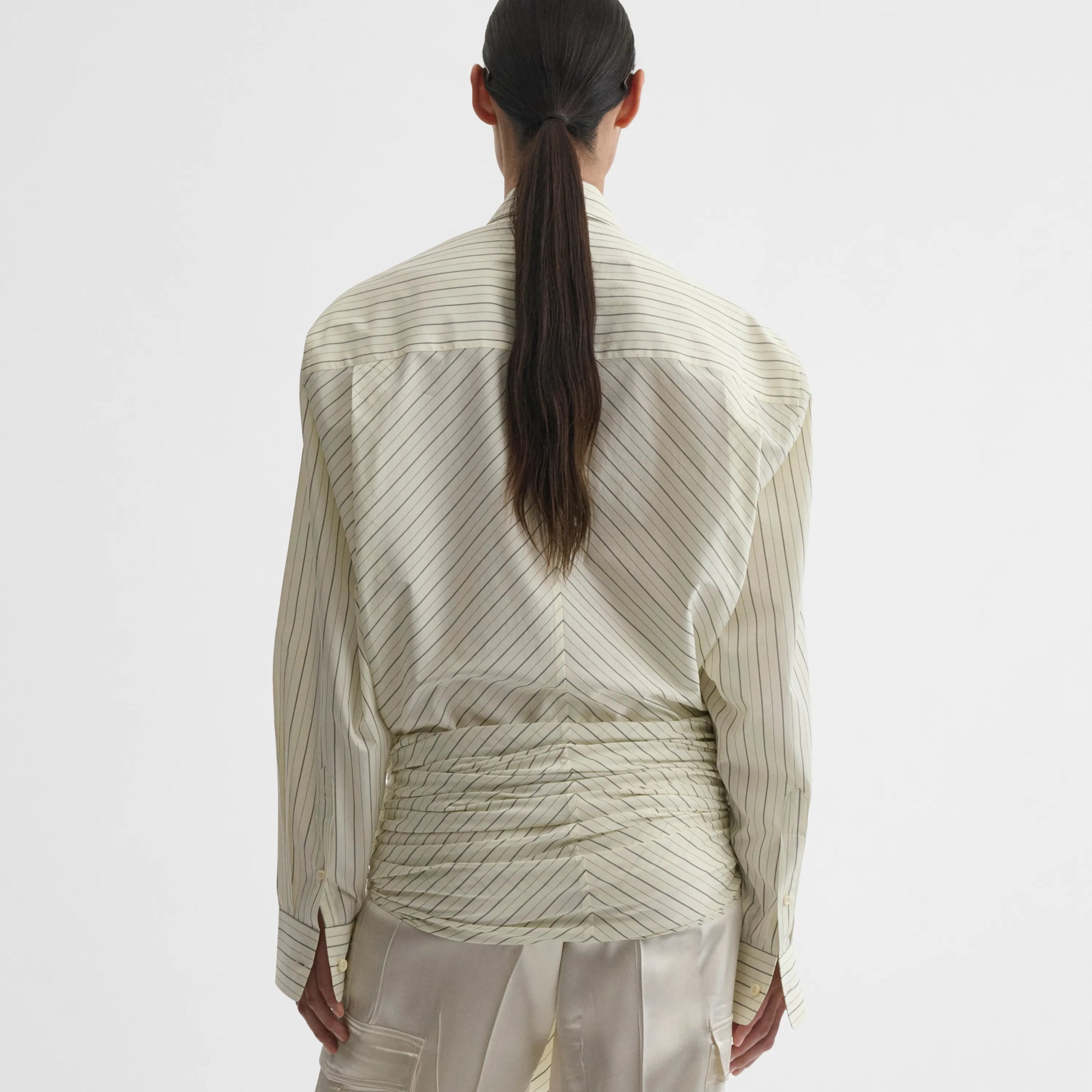 Back view of dropped front shirt in pale lemon cotton