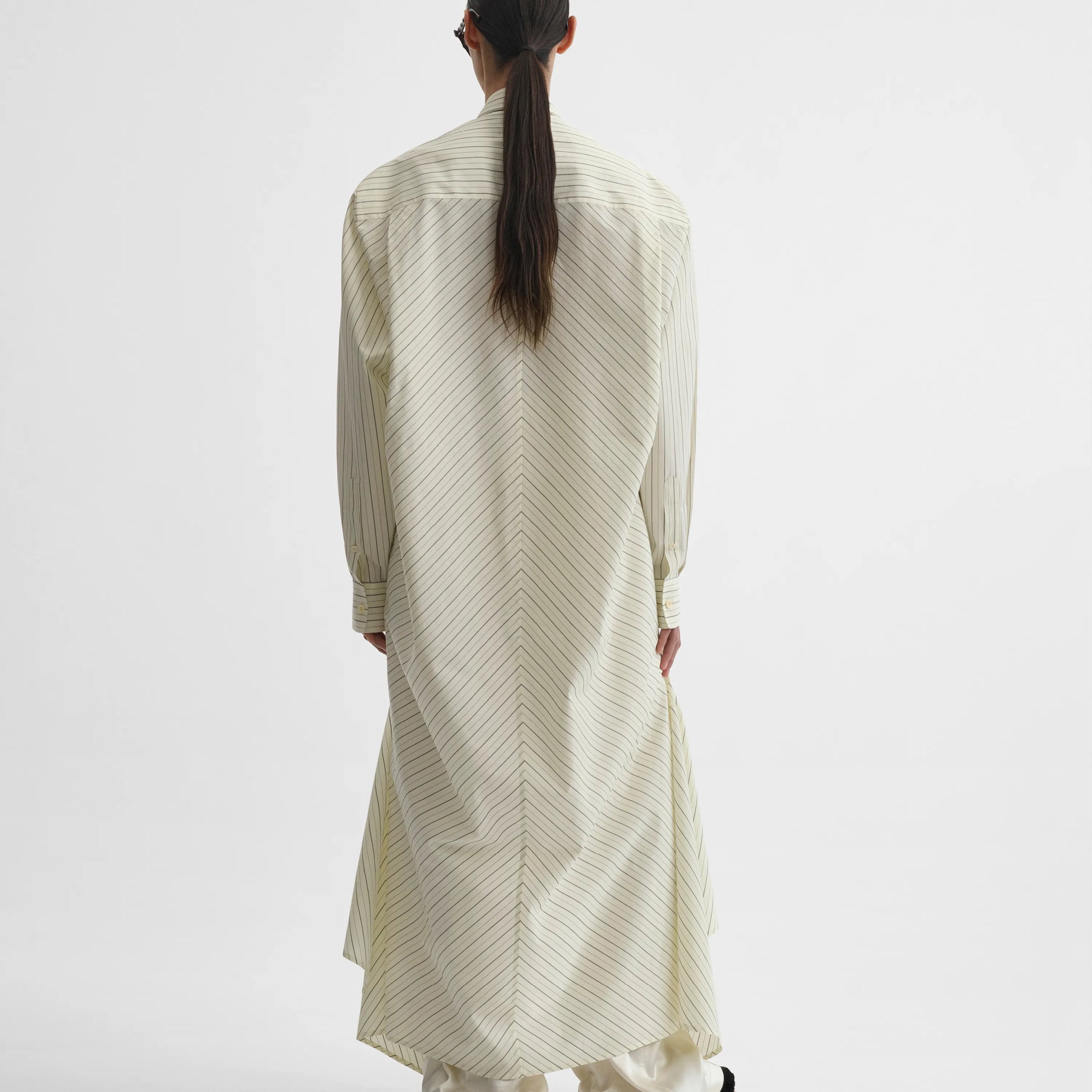 Back view of dropped front shirt in pale lemon cotton
