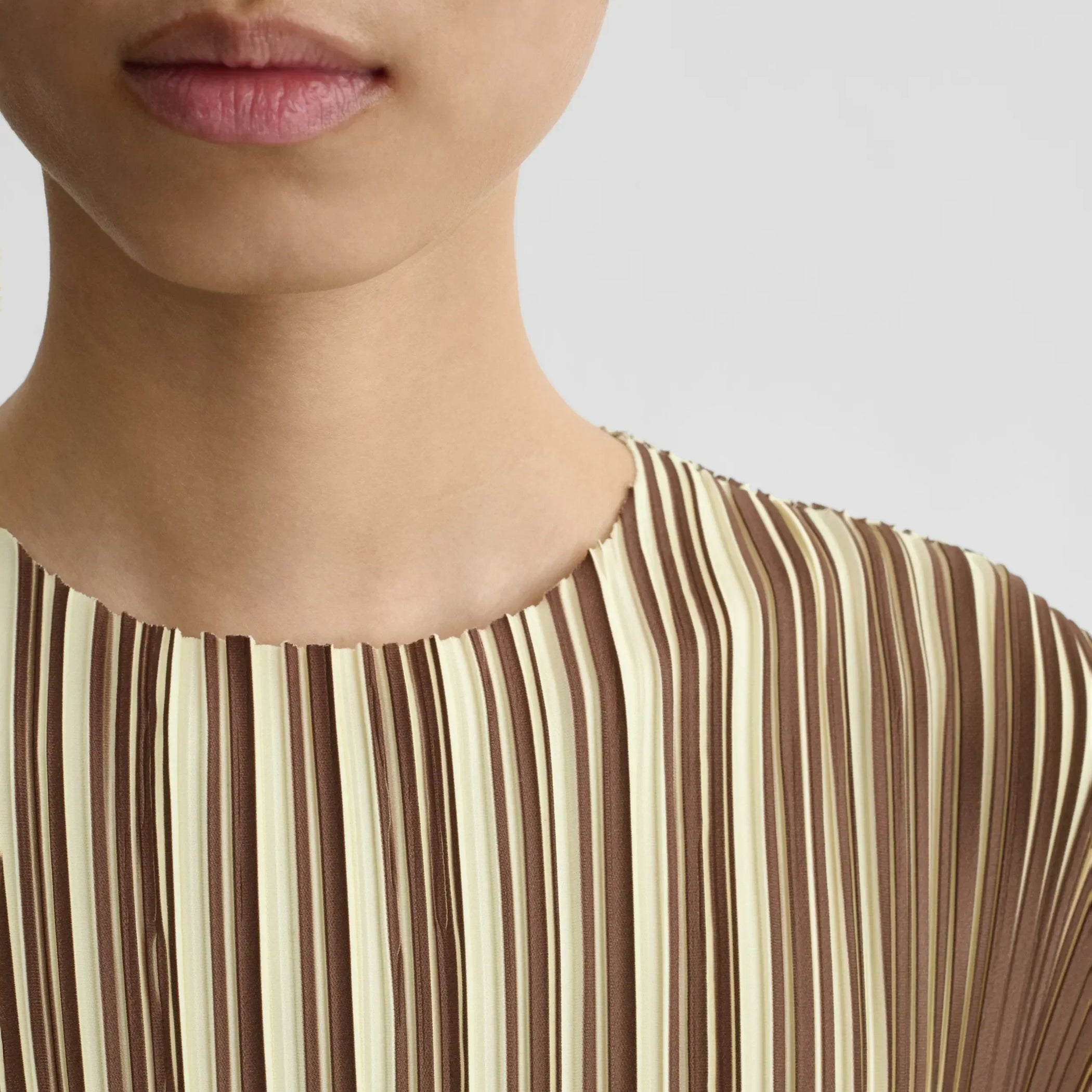 Close up view of razor pleat dress in khaki cotton