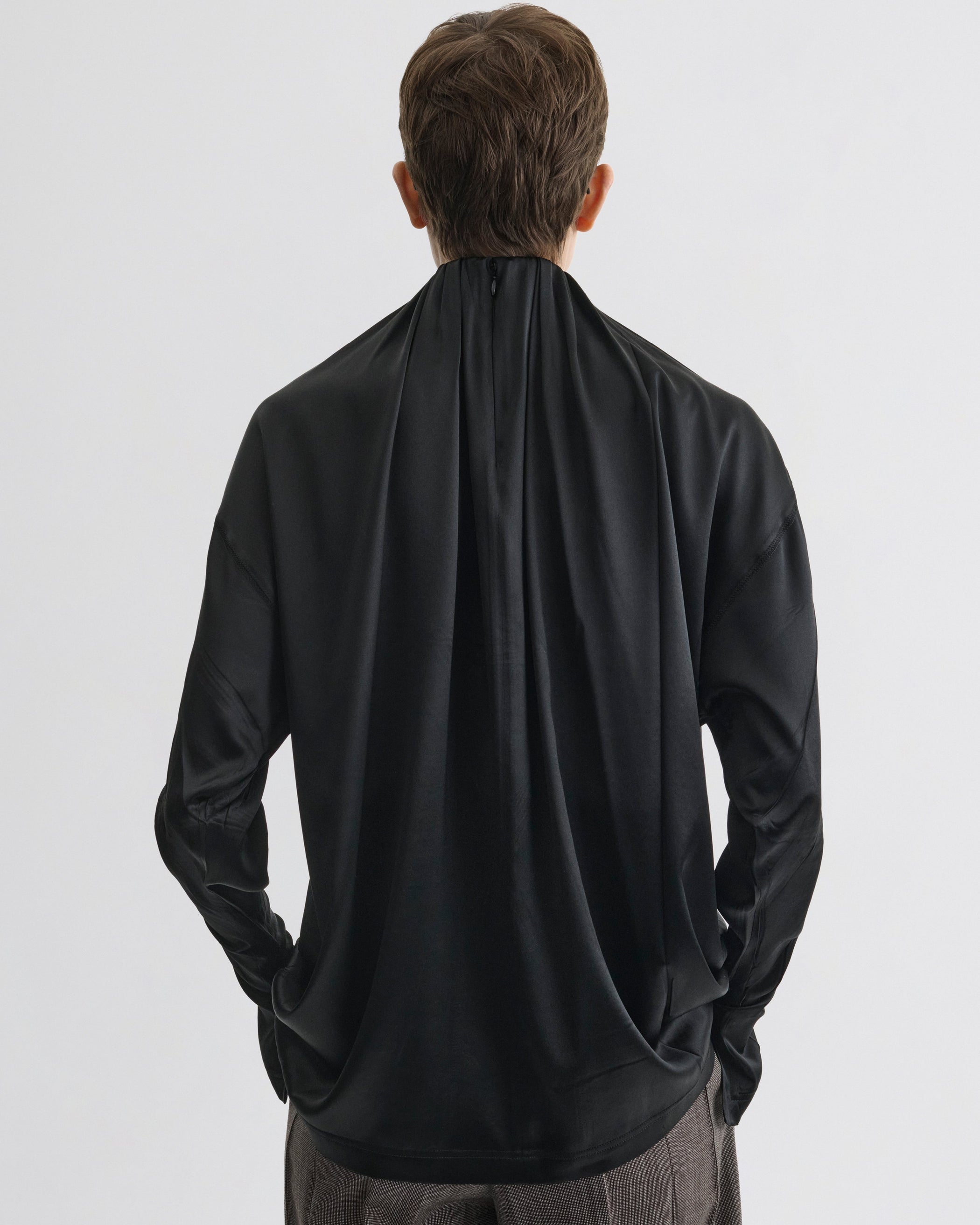 Back view of model wearing LIQUID SOFT RIDGE TOP in black silk