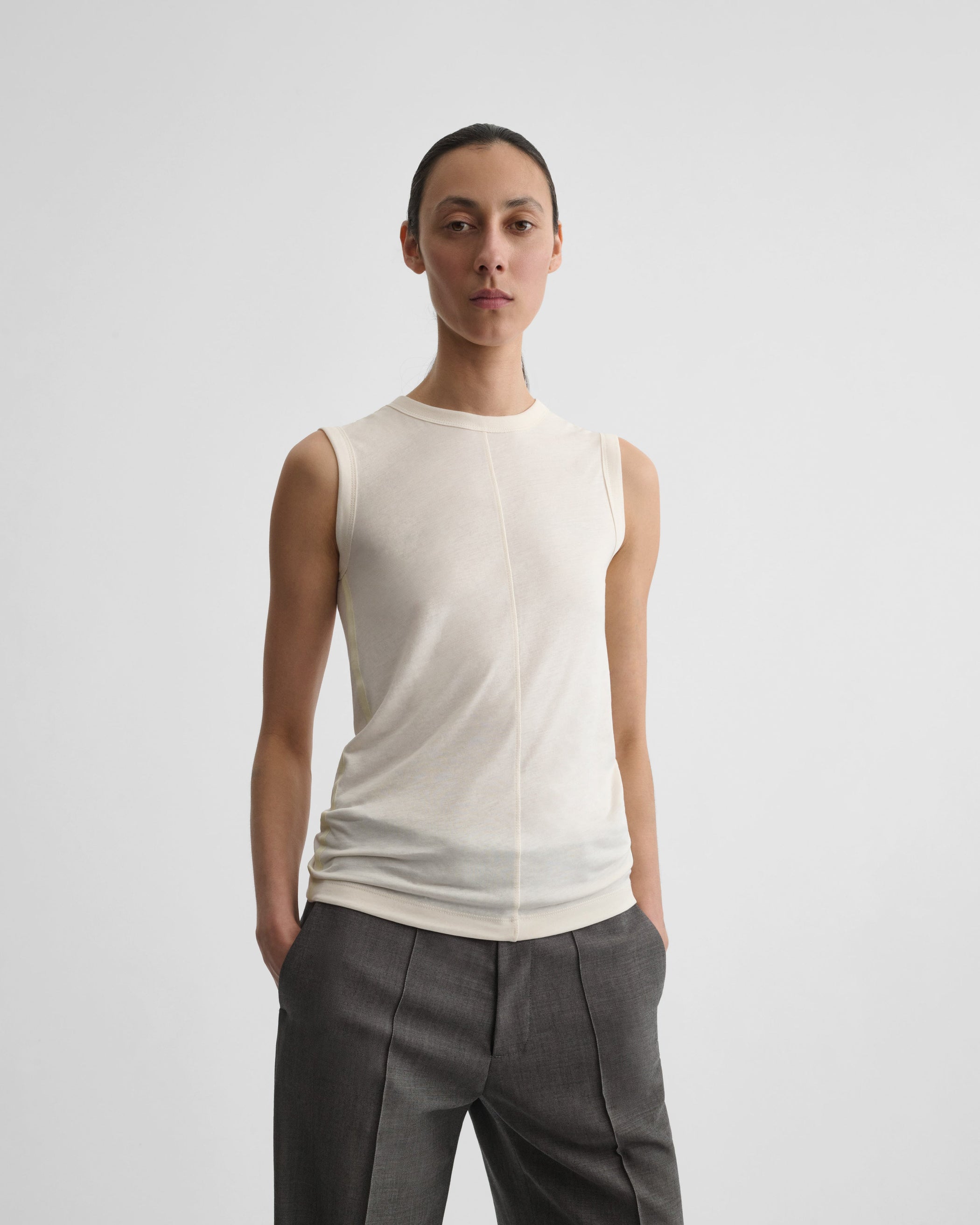 Front view of model wearing UNDERPINNING TANK TOP in ivory cotton