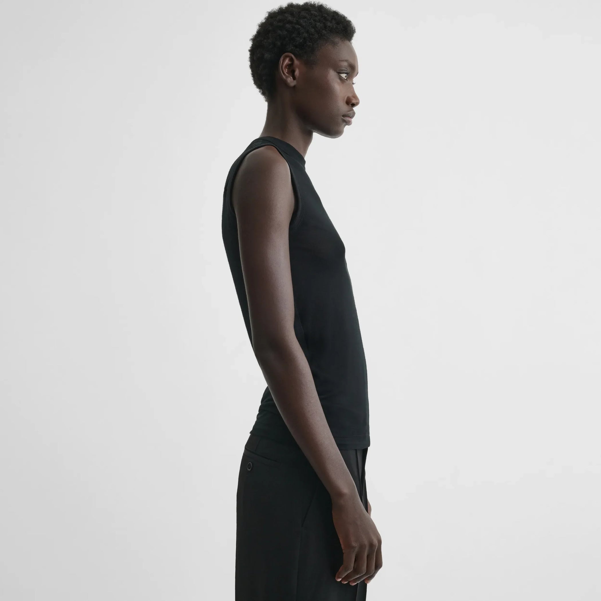 Side view of underpinning tank top in black cotton
