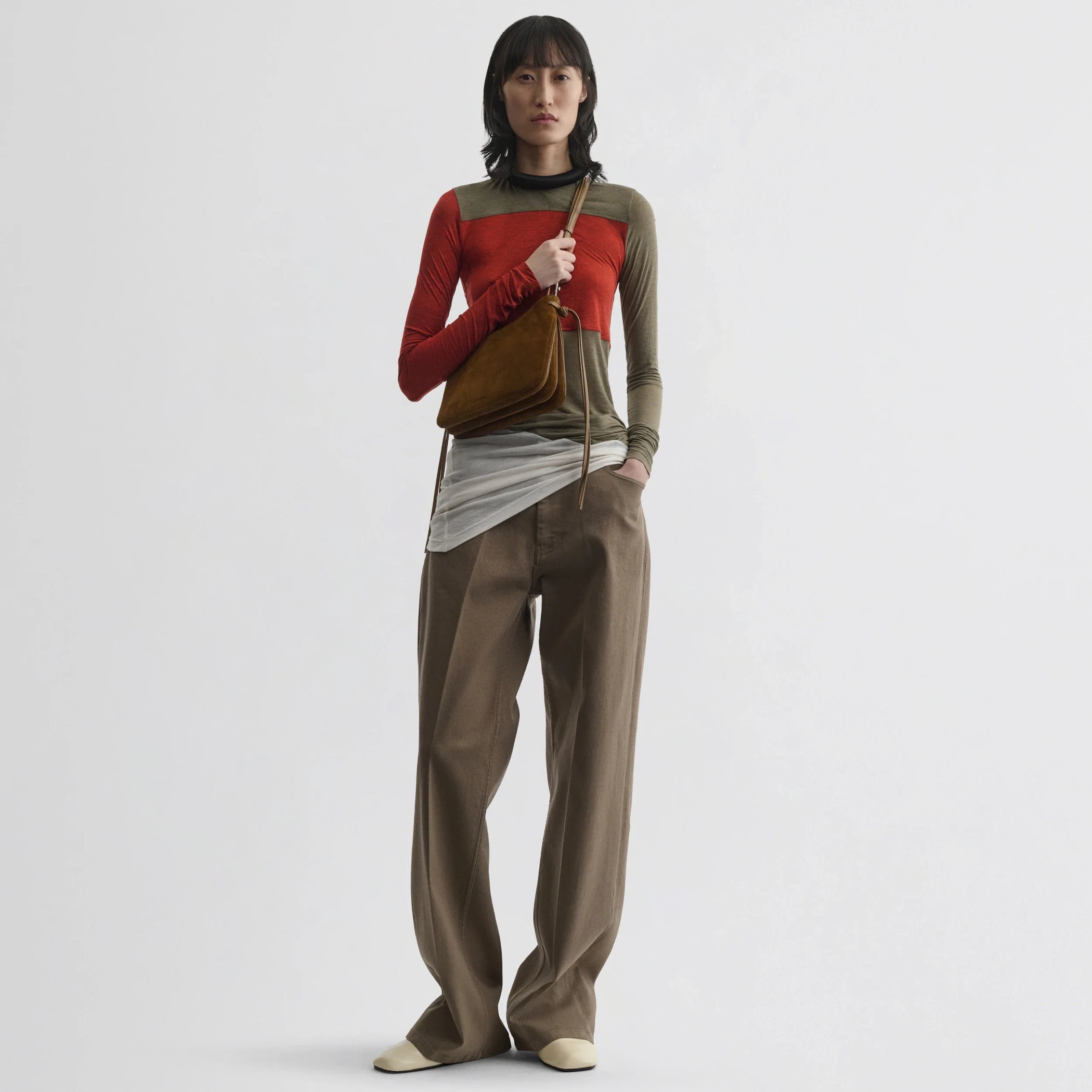 Front view of model wearing tubular colour block top in ivory tobacco red cotton.
