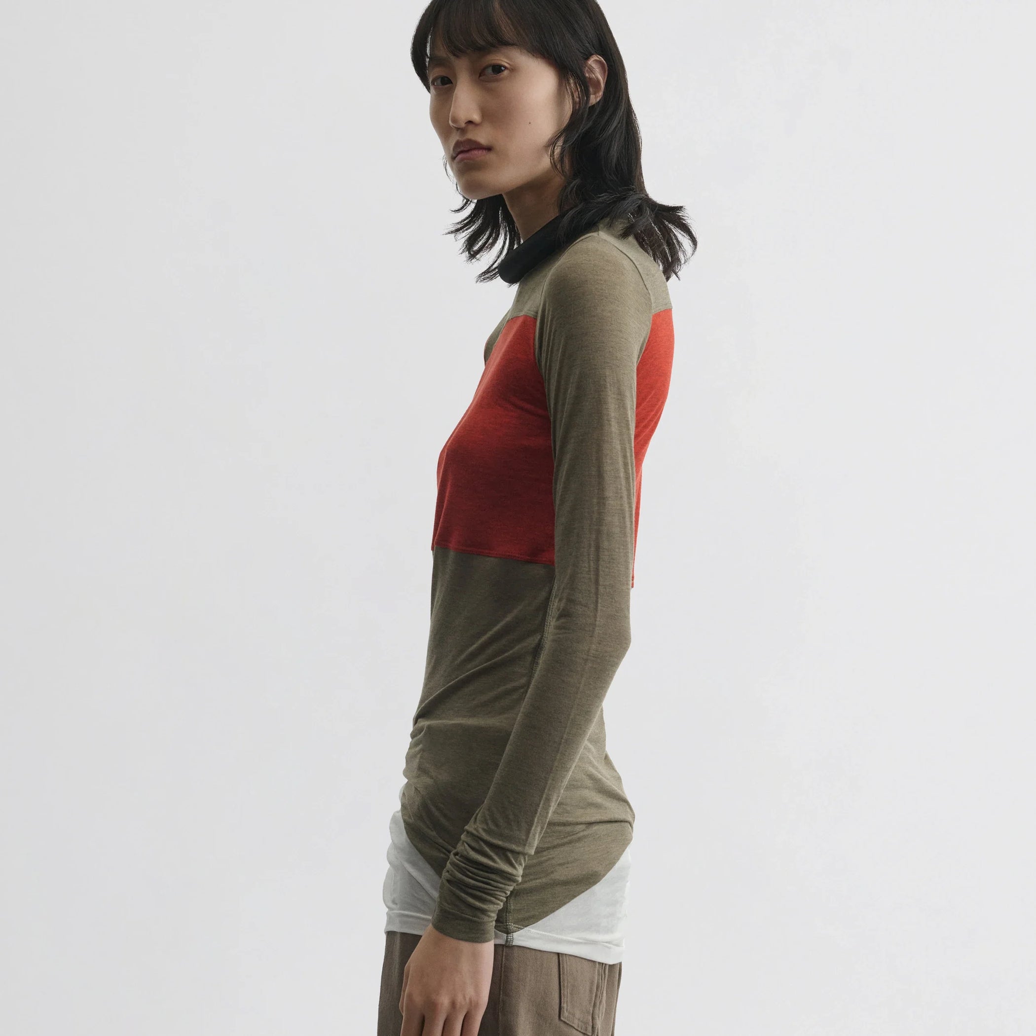 Side view of model wearing tubular colour block top in ivory tobacco red cotton.