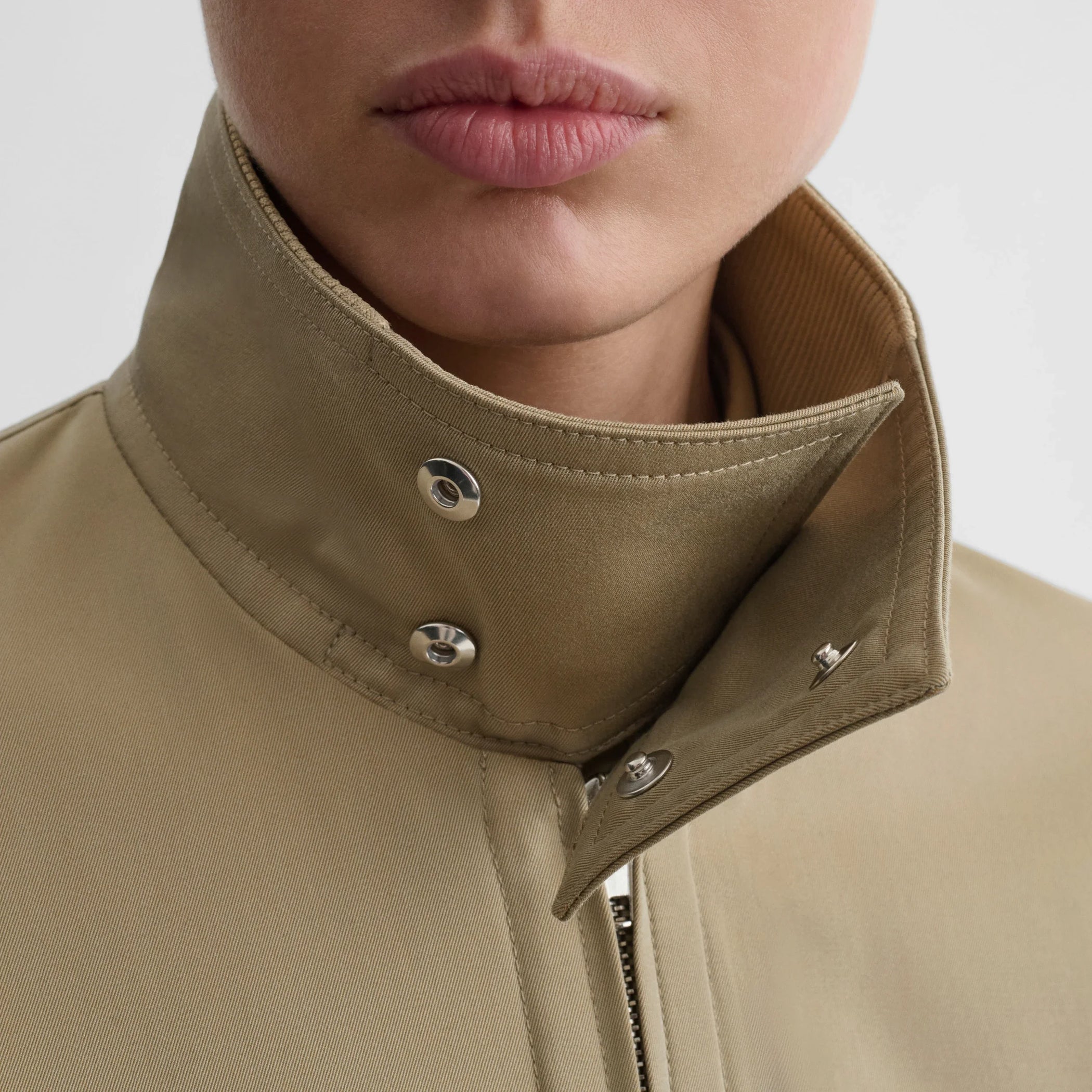 Close up detail view of golf jacket in trench cotton.