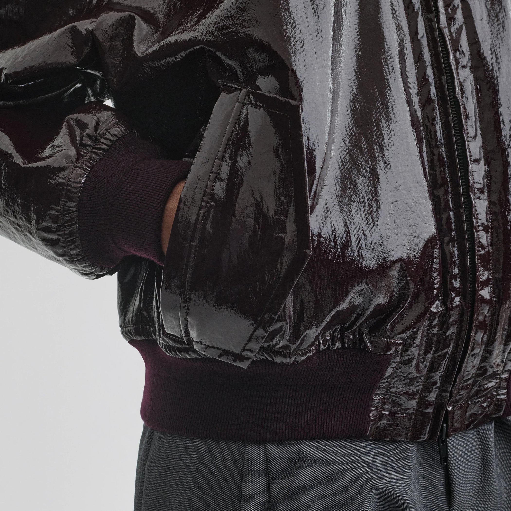 Close up detail view of golf jacket in burgundy linen canvas.