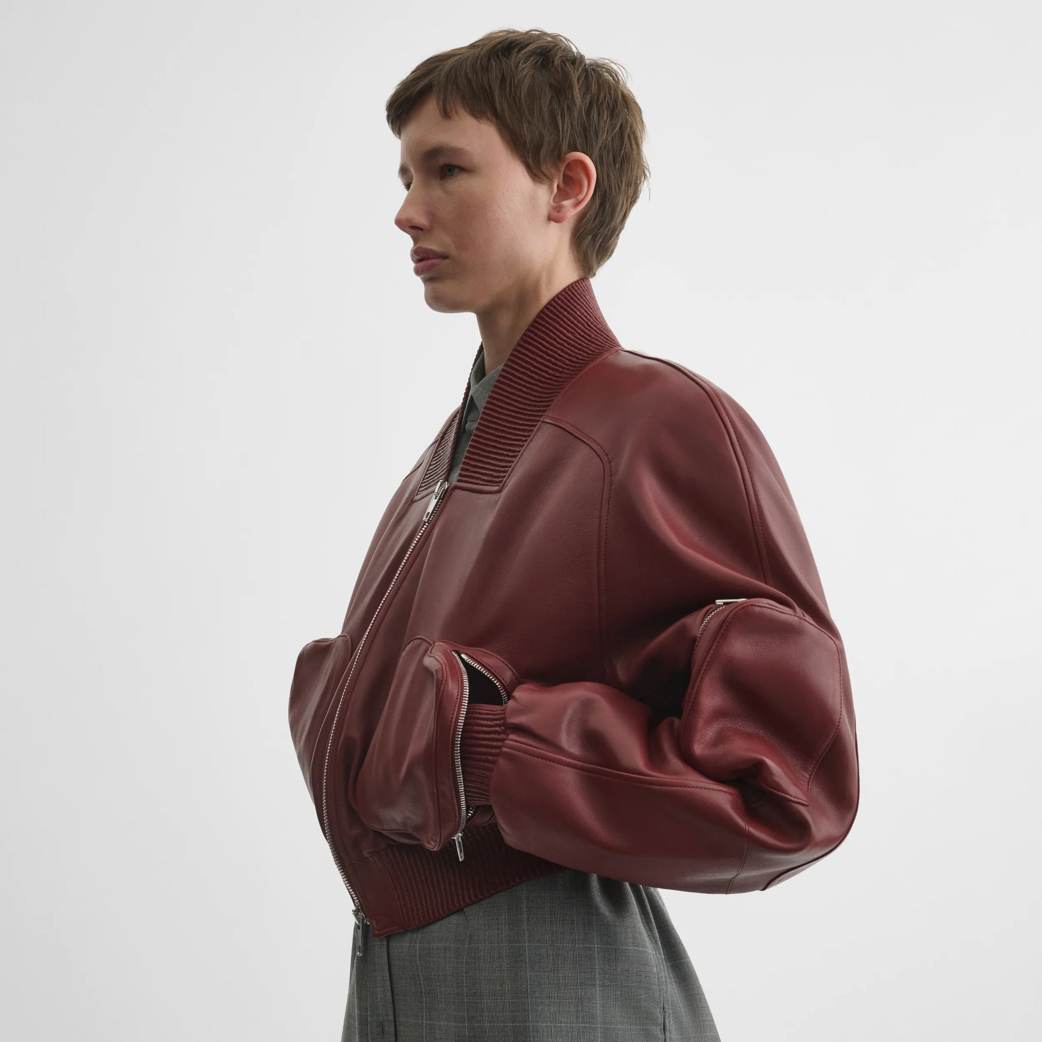 Side view of pocket bomber jacket in brick leather