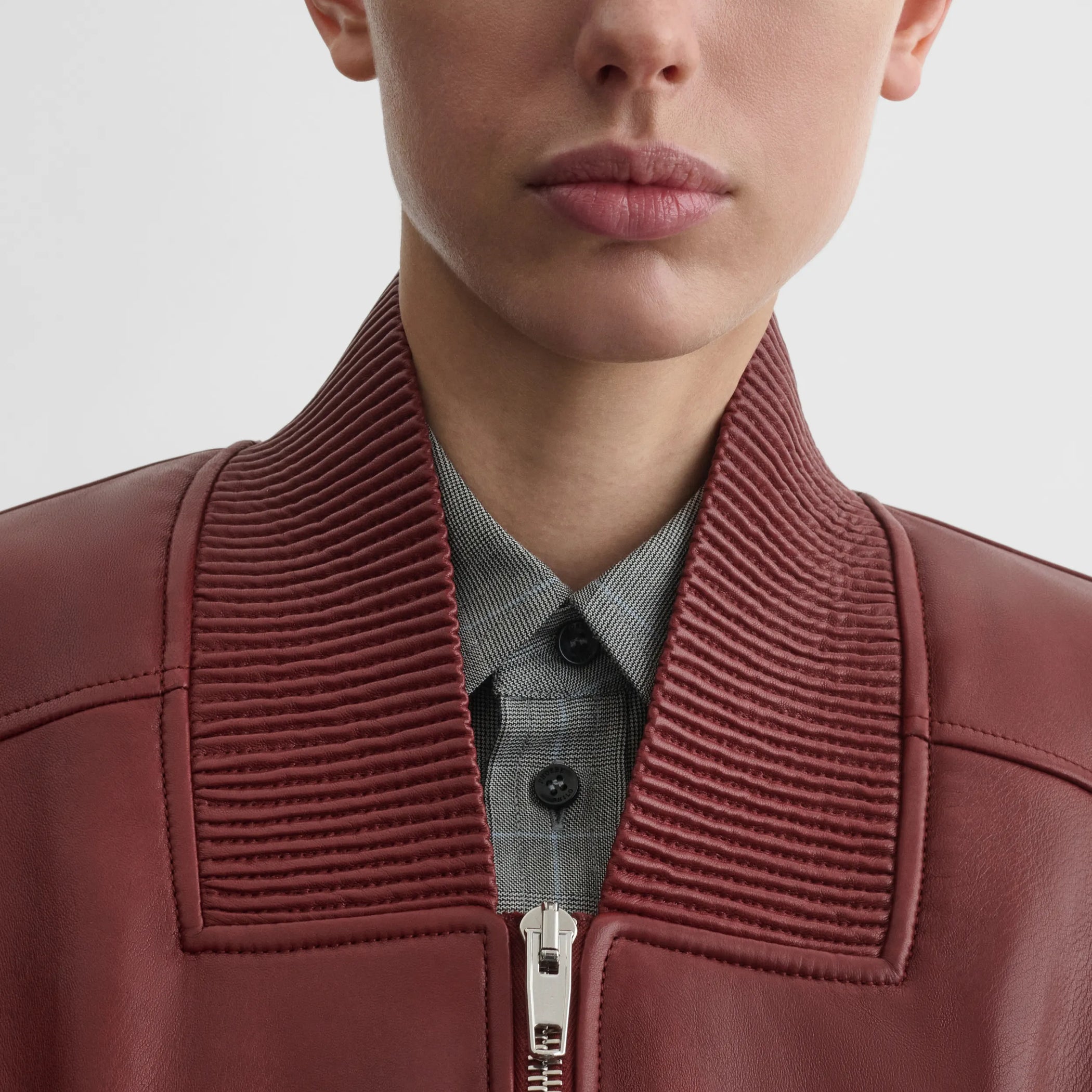 Close up detail view of pocket bomber jacket in brick leather
