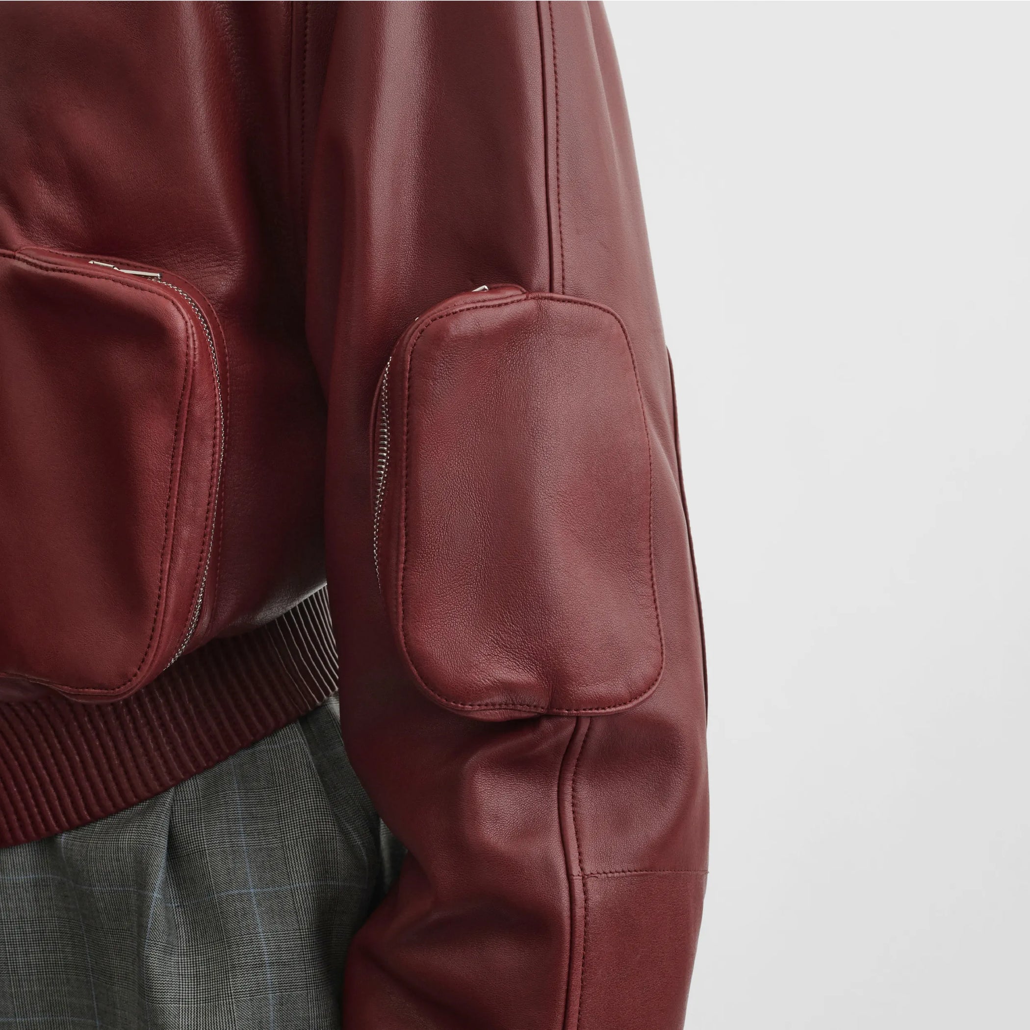 Close up detail view of pocket bomber jacket in brick leather