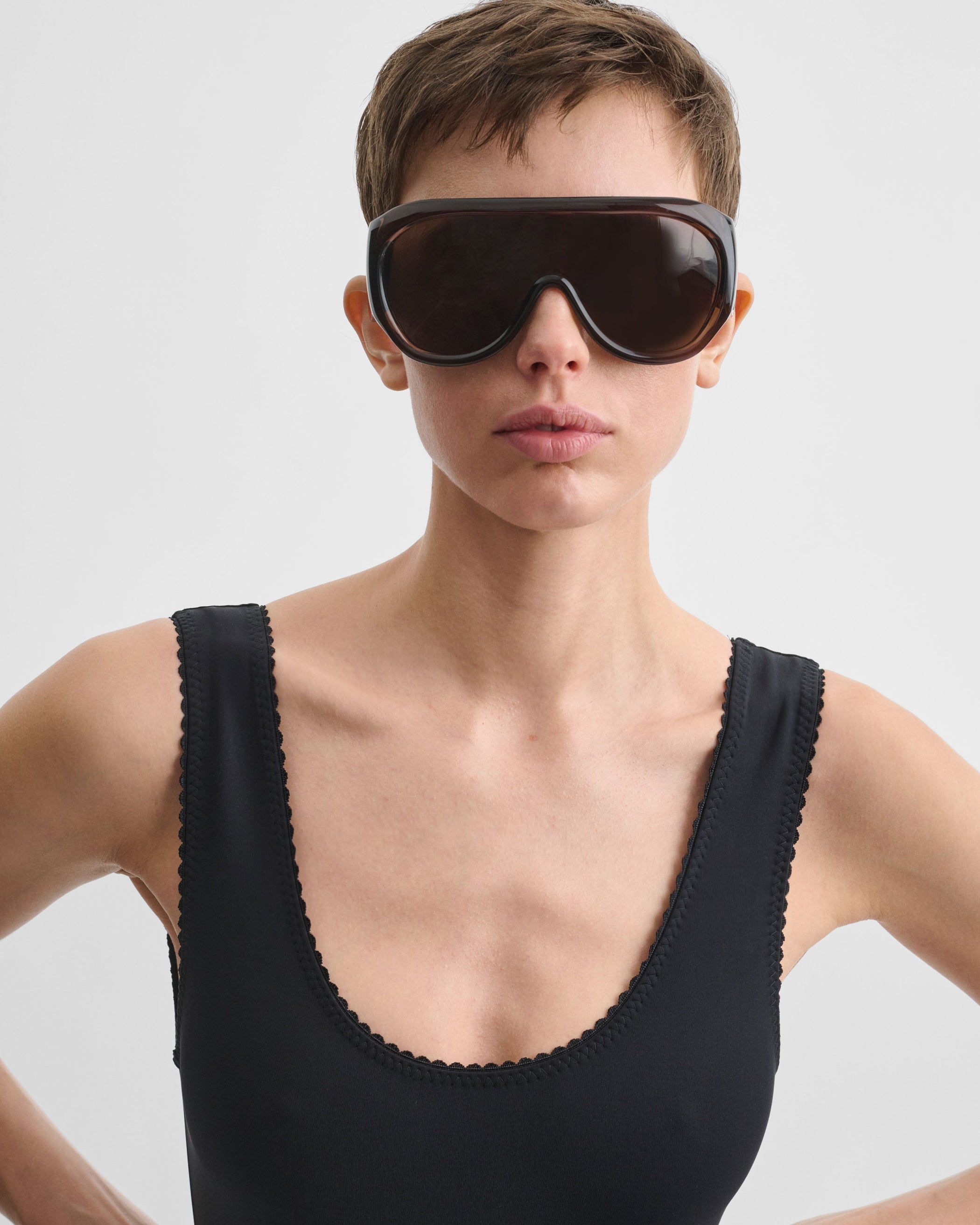 Front view of model wearing SCOOPED ONE PIECE in black nylon