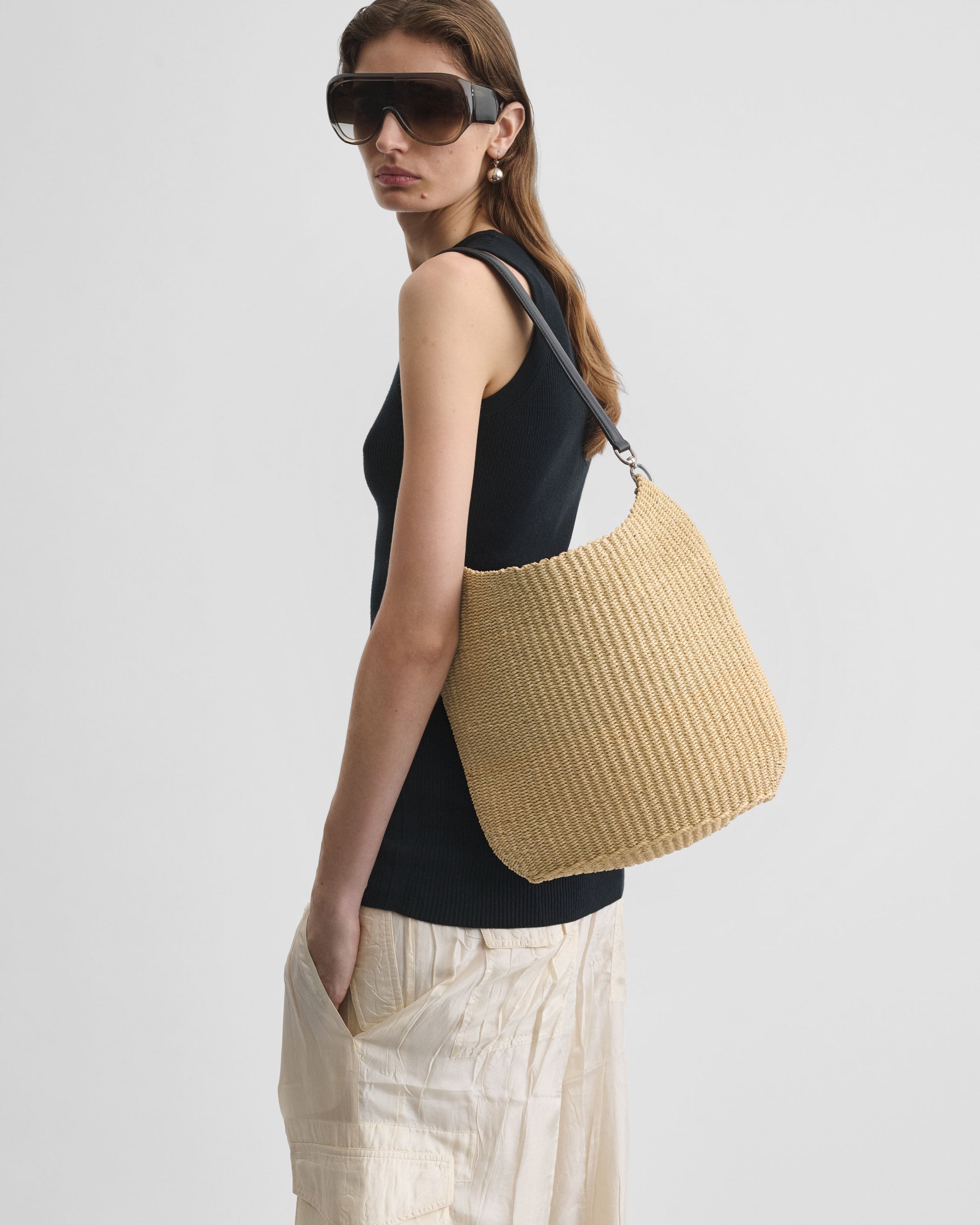 View of model wearing SMALL SLOPE SLING in natural woven viscose