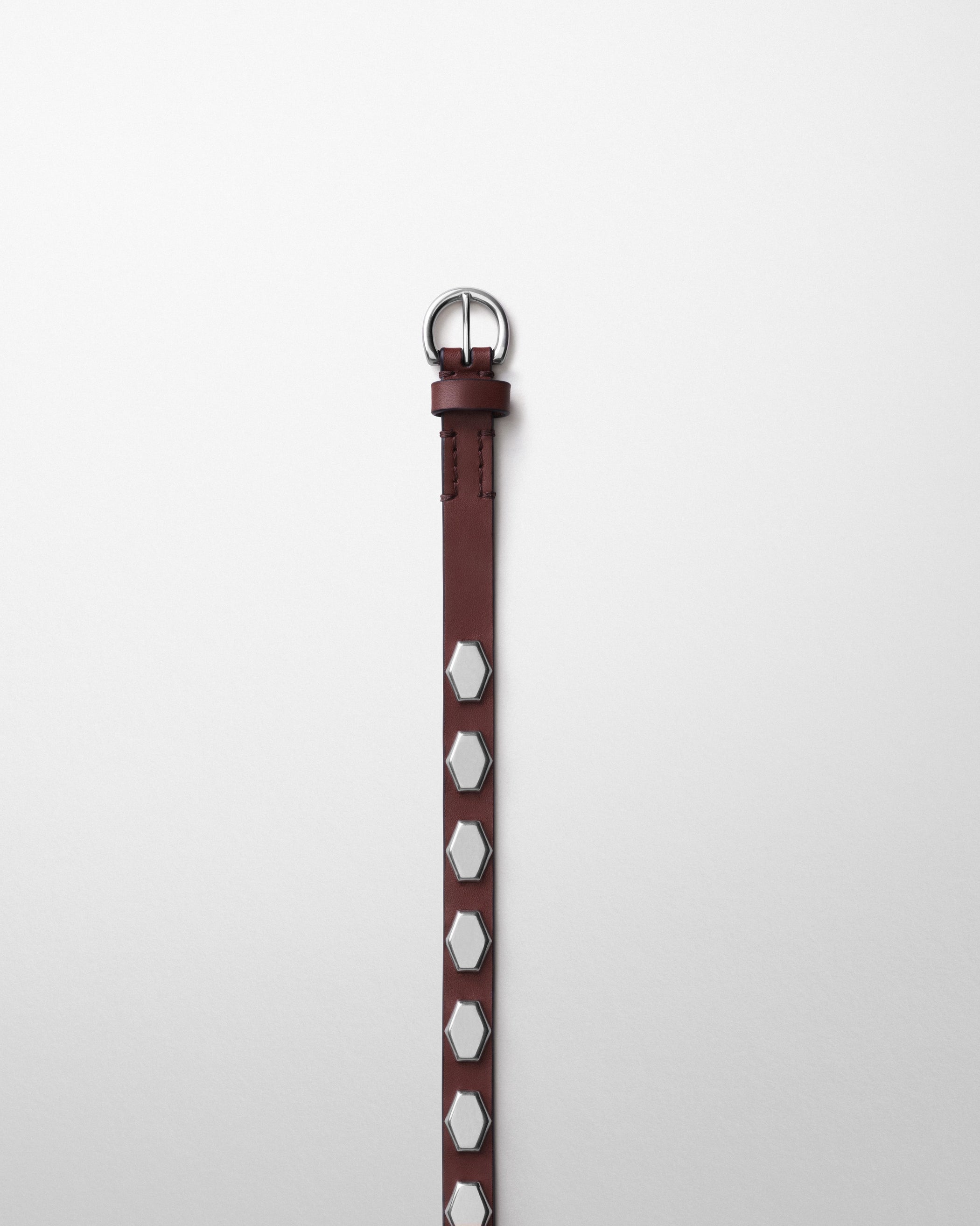 Detail view of NARROW STUD BELT in oxblood leather