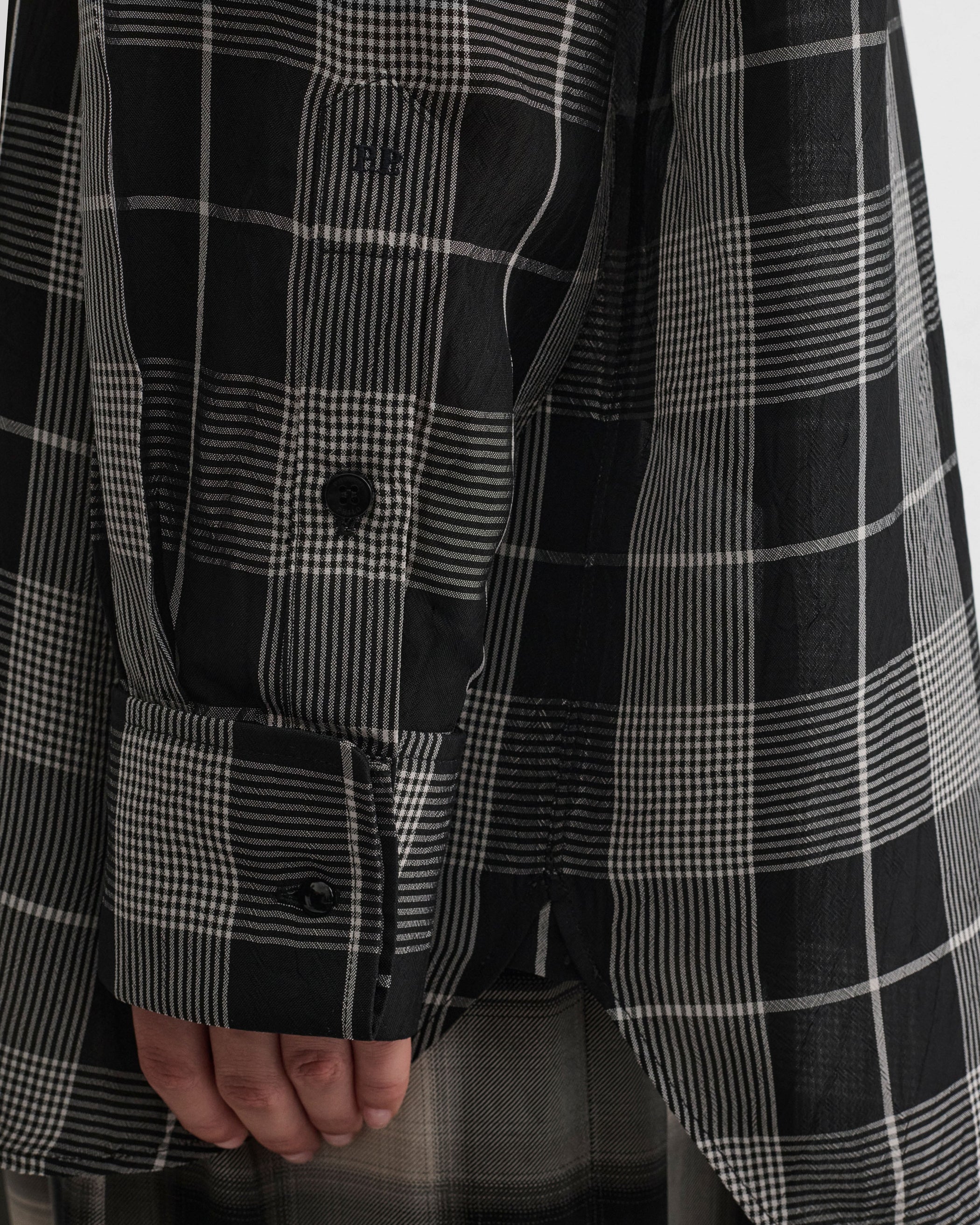 Close up detail view of model wearing CUSTOM TUX SHIRT in b/w check viscose