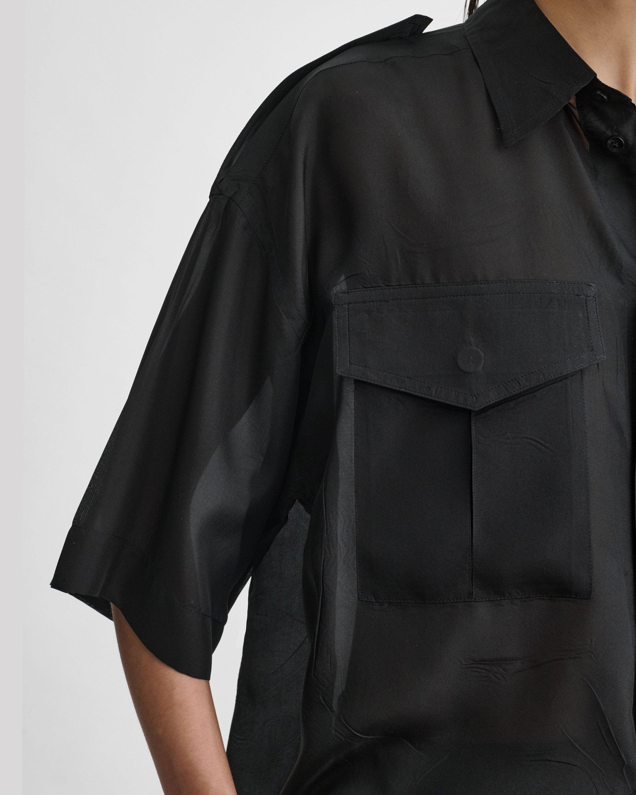 Detail view of model wearing LITE UTILITY SHIRT in black habotai silk
