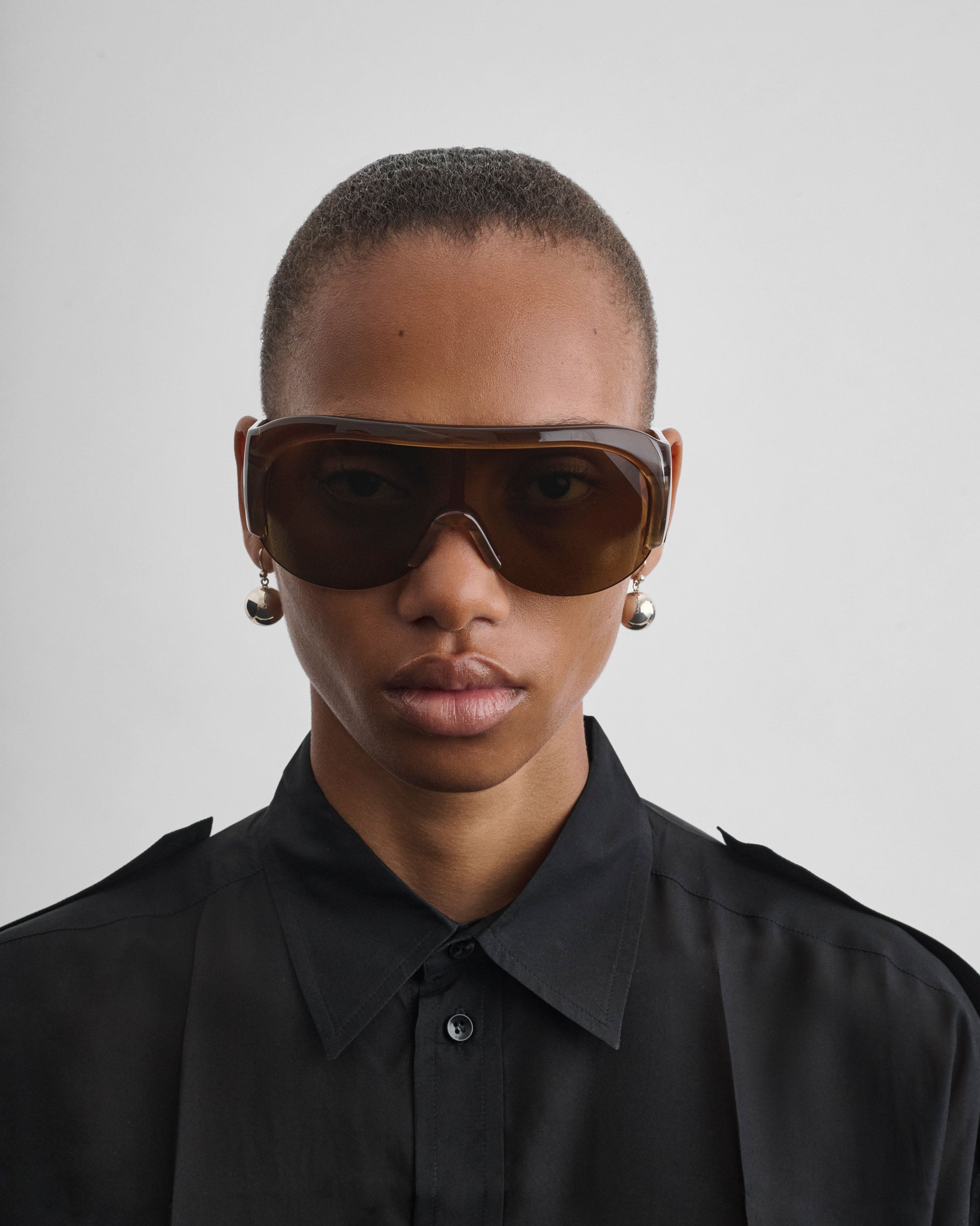 Front view of model wearing HALF BOMBE SUNGLASSES in conker tortoiseshell acetate