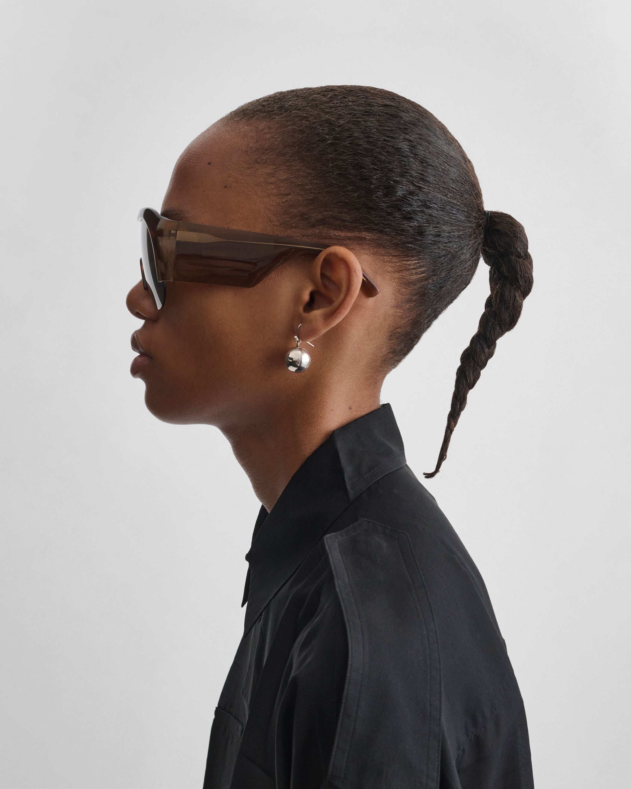 Side view of model wearing HALF BOMBE SUNGLASSES in conker tortoiseshell acetate