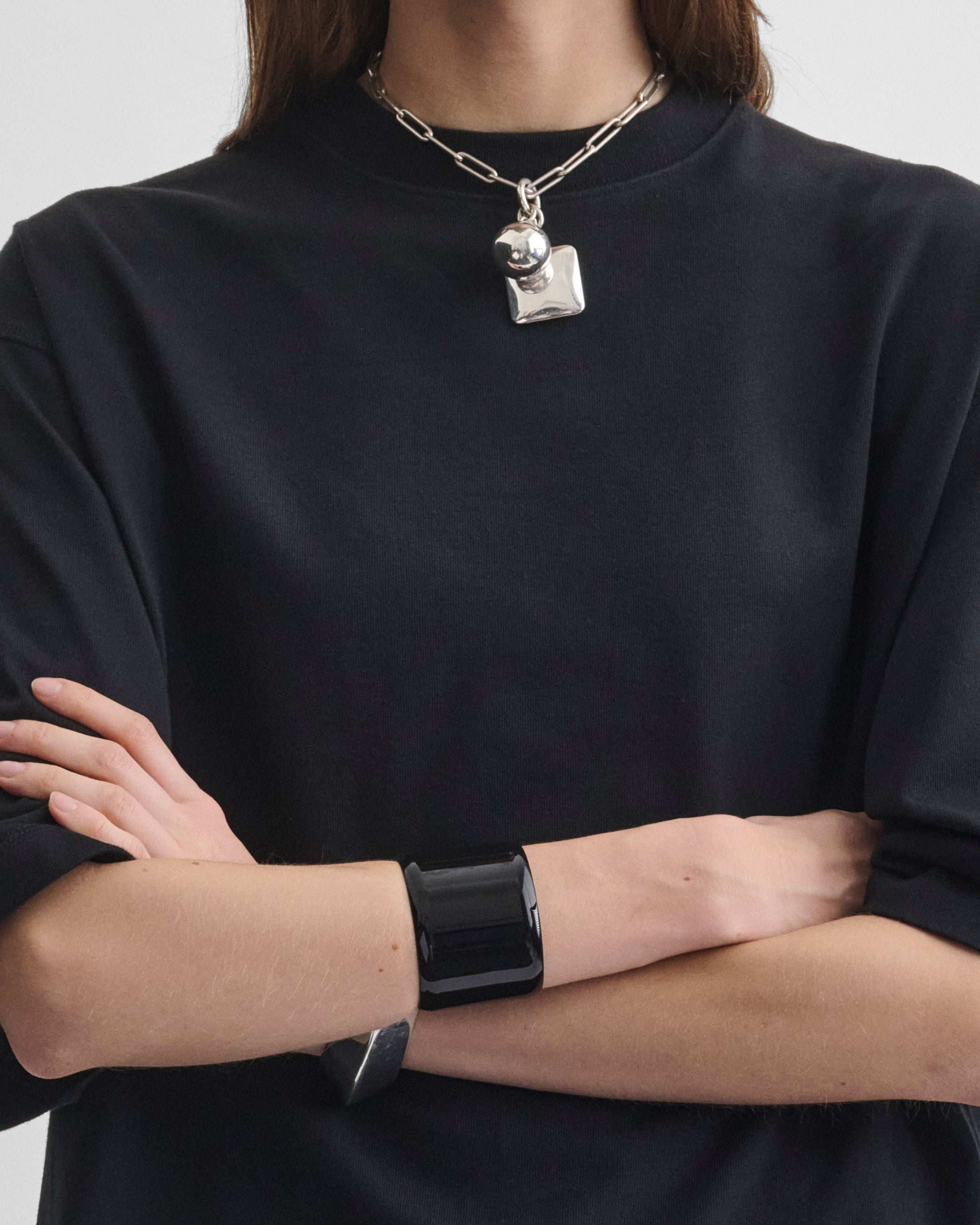 Front view of model wearing PURE BANGLE in black
