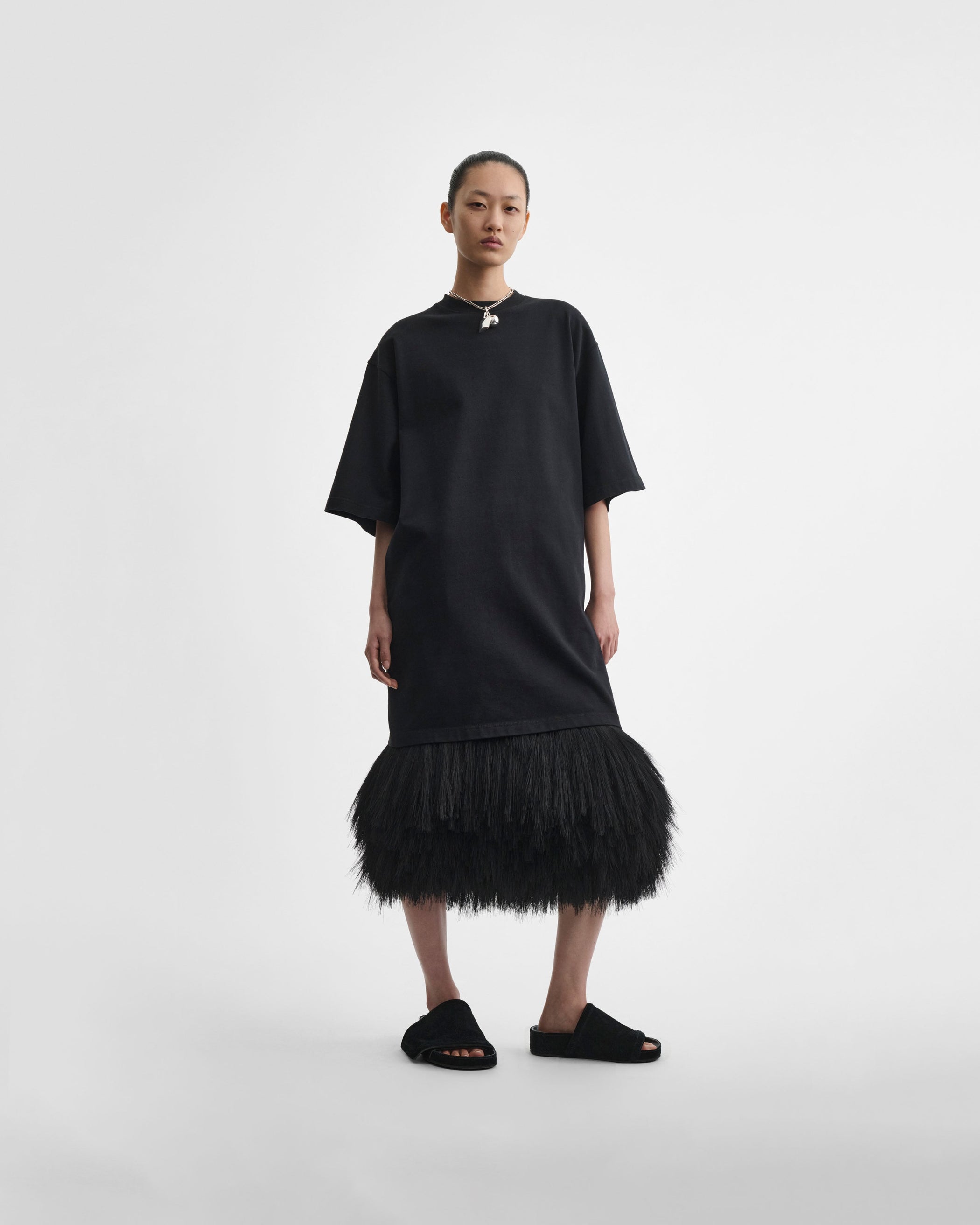 Front view of model wearing FRINGED SLIP SKIRT in black silk