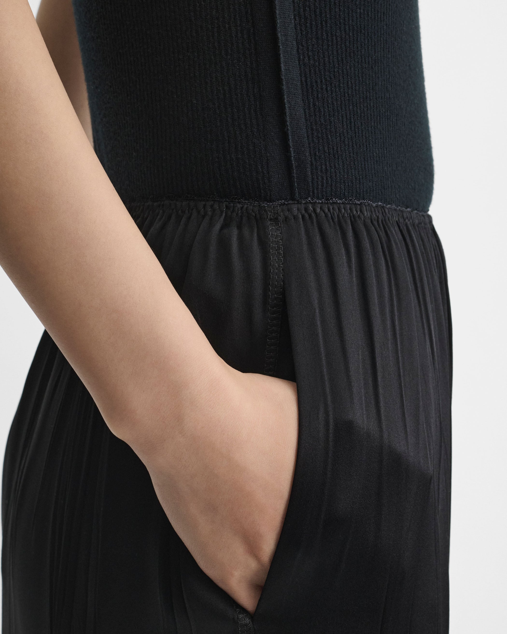 Detail view of model wearing FRINGED SLIP SKIRT in black silk