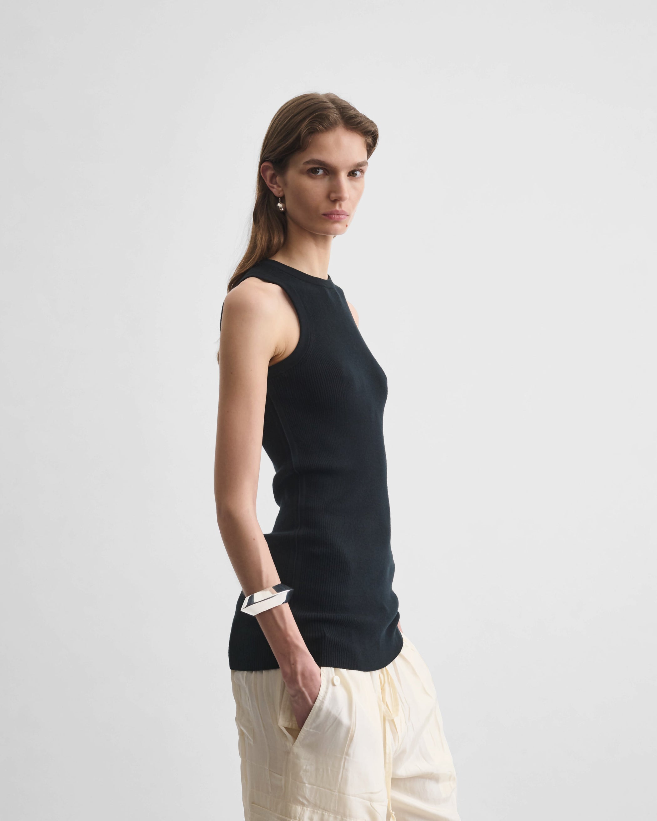 Side view of model wearing the RIB TANK in black wool