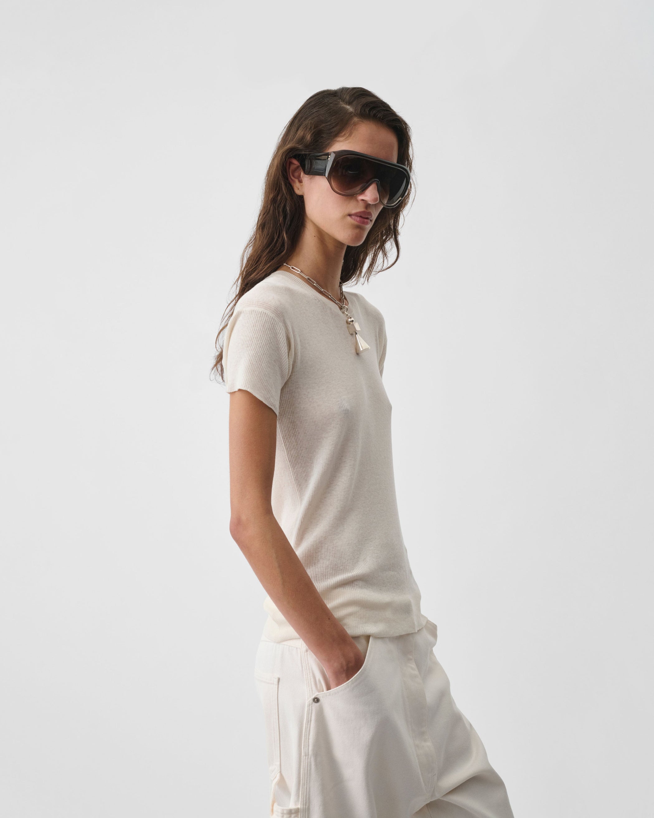Side view of model wearing SCOOP NECK RIB T-shirt in ivory cotton