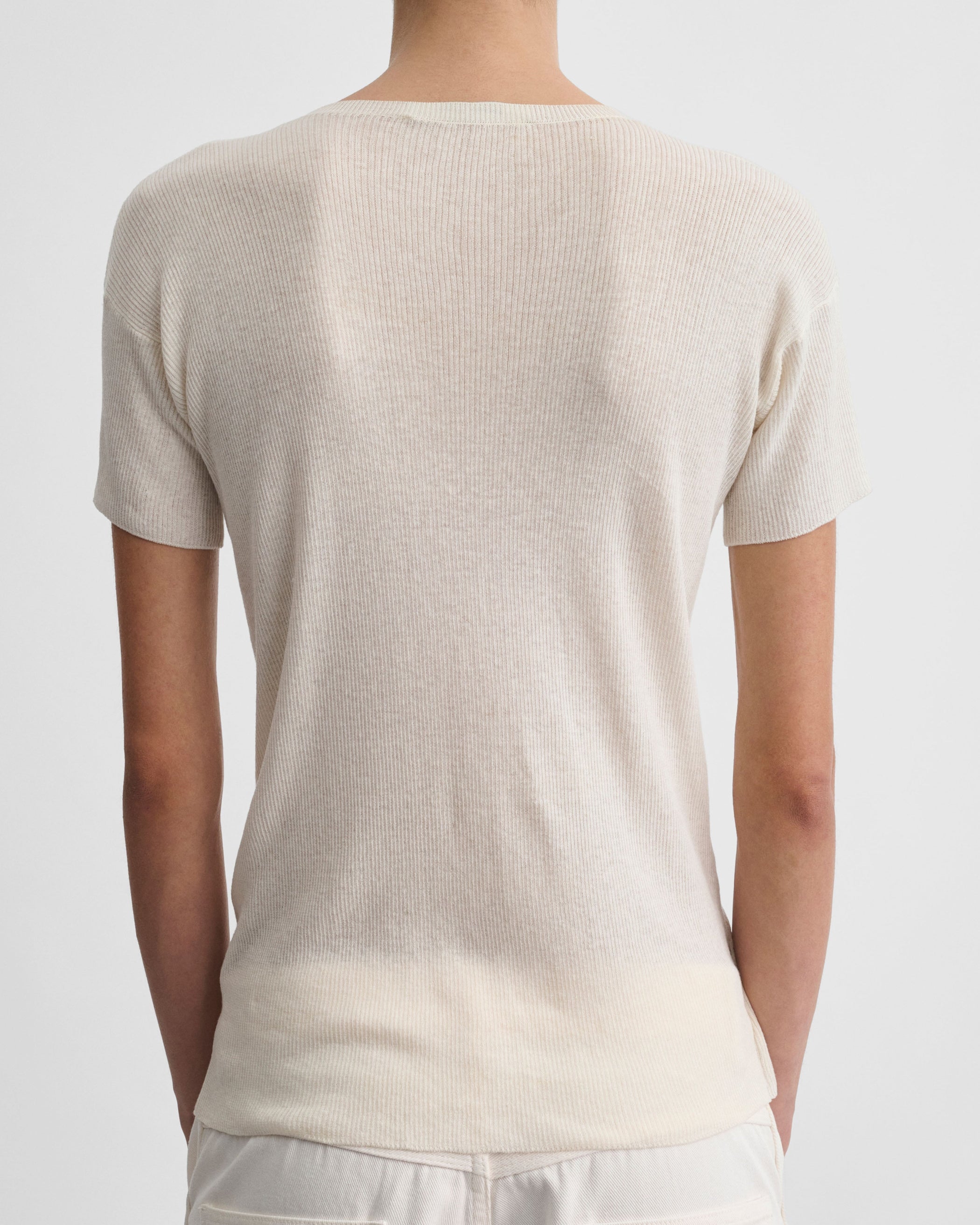 Back view of model wearing SCOOP NECK RIB T-shirt in ivory cotton
