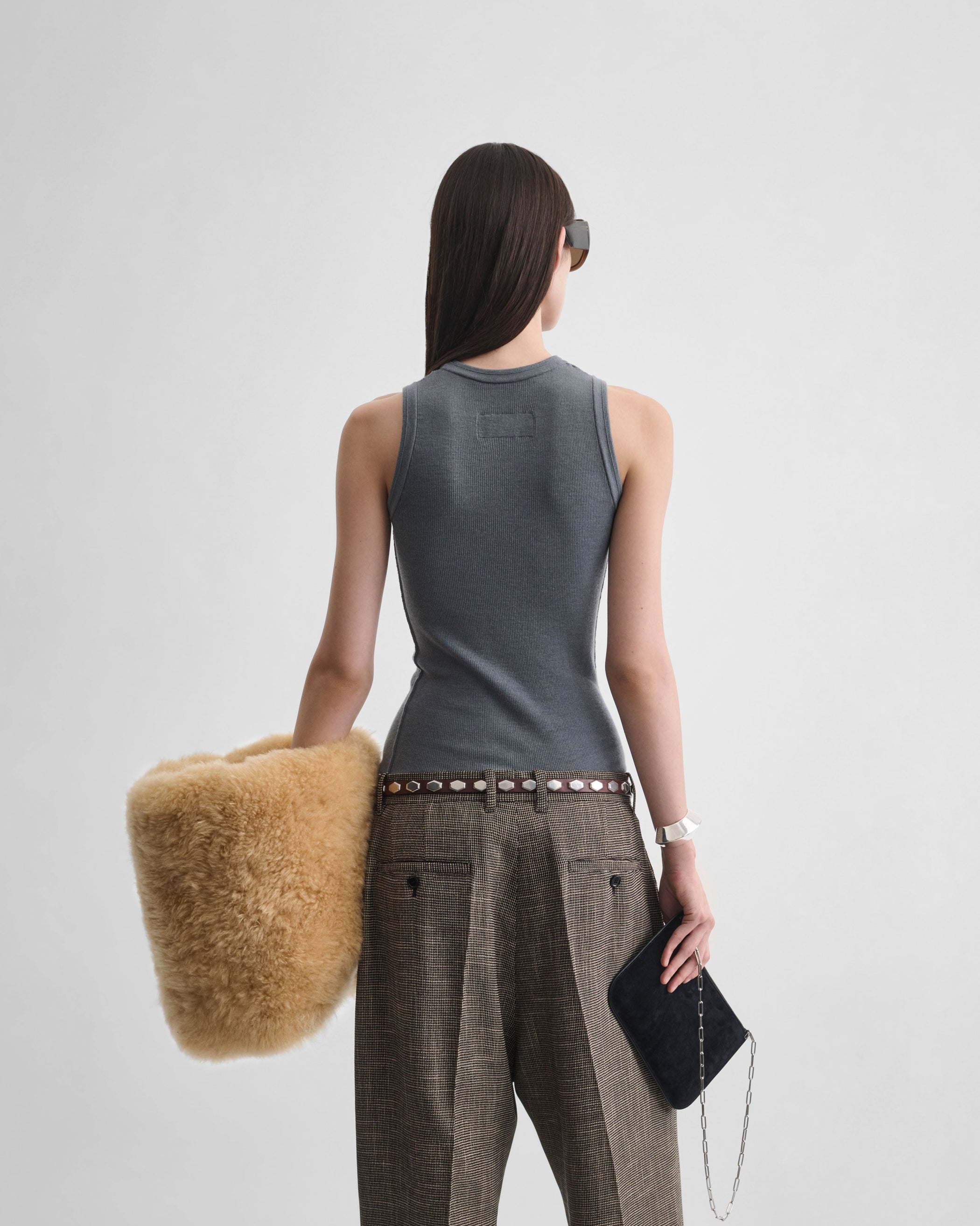 Back view of model wearing RIBBED TANK in moss green wool