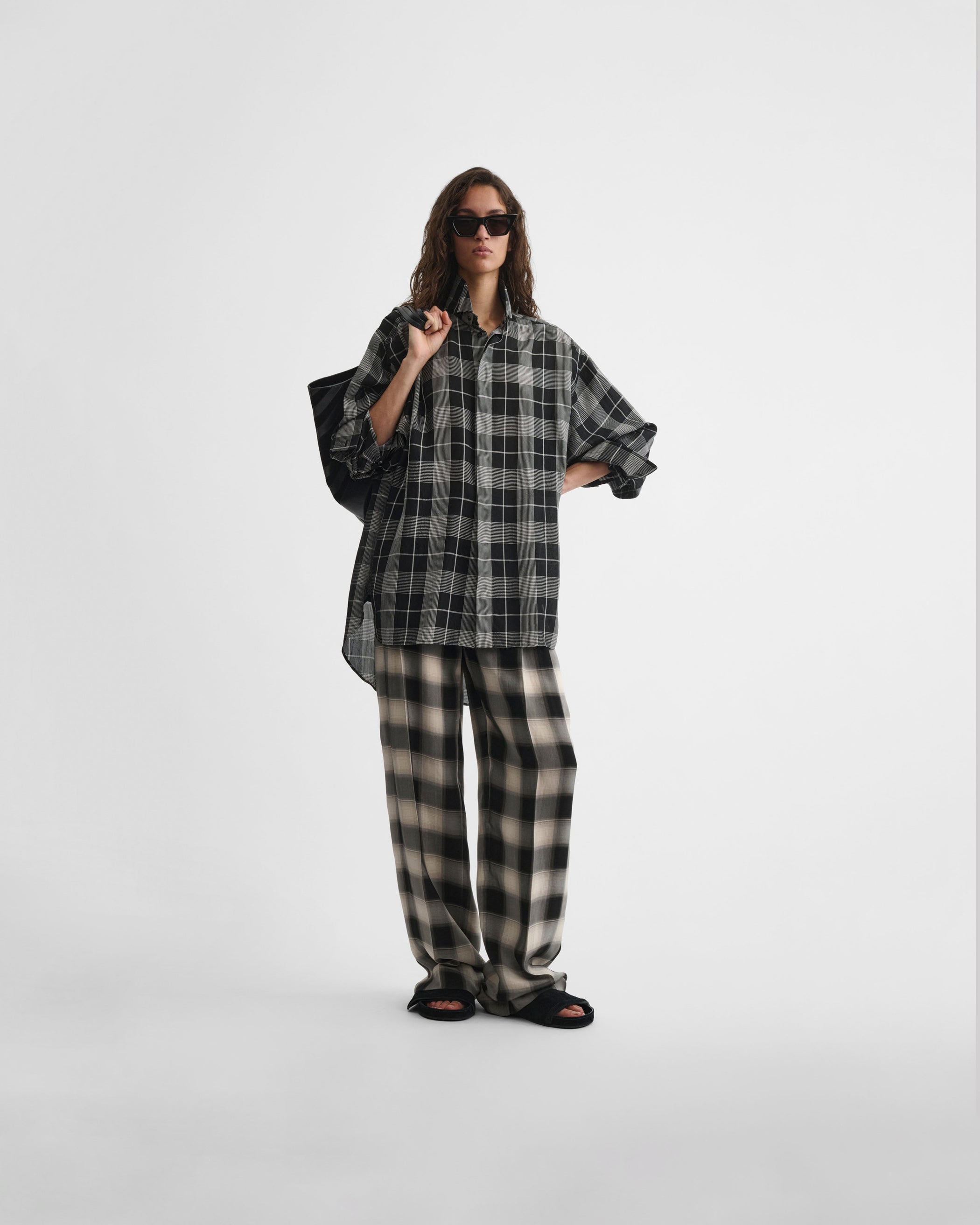 Front view of model wearing DOUBLE PLEAT TROUSERS in salt and pepper woven viscose