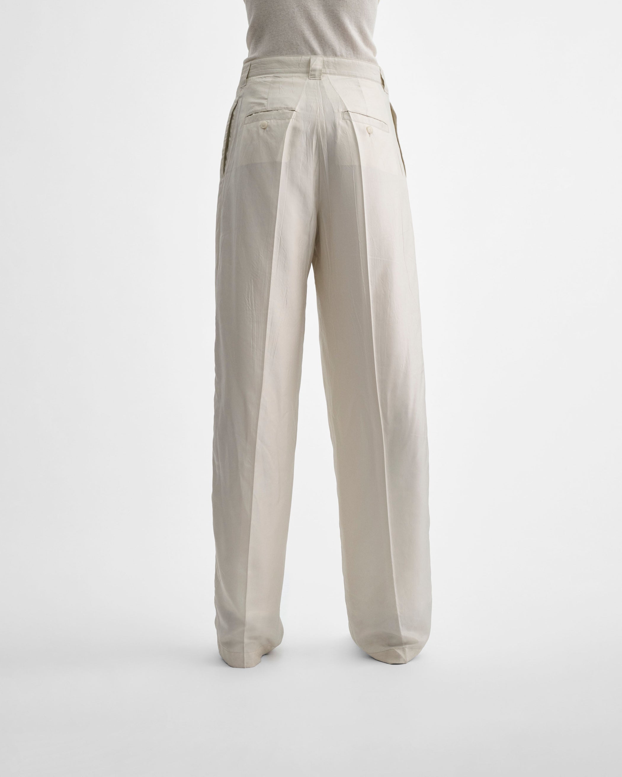 Back view of model wearing CHINO TROUSERS in salt technical twill