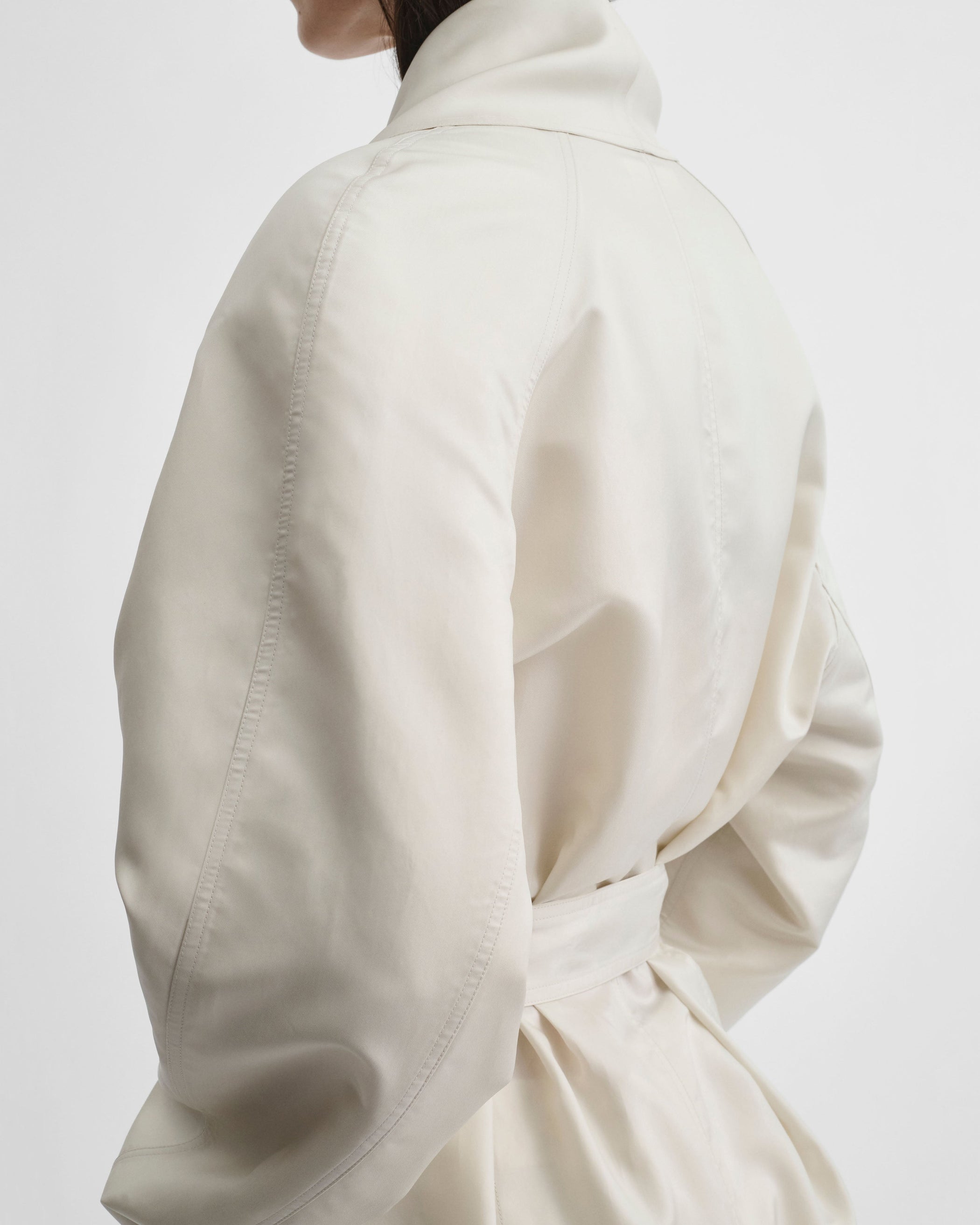 Back detail view of model wearing BELTED ROBE DRESS in salty white silk