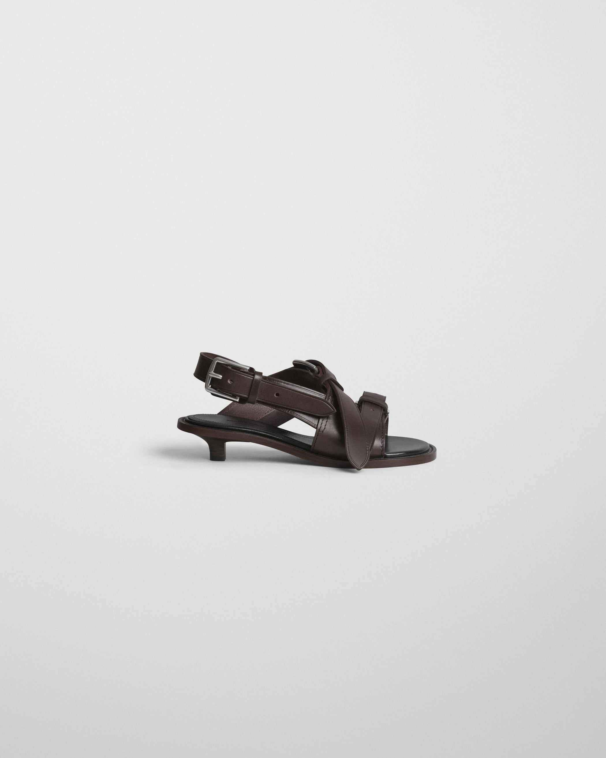 Flat side view of LOW BUCKLE SANDAL 30 in umber leather