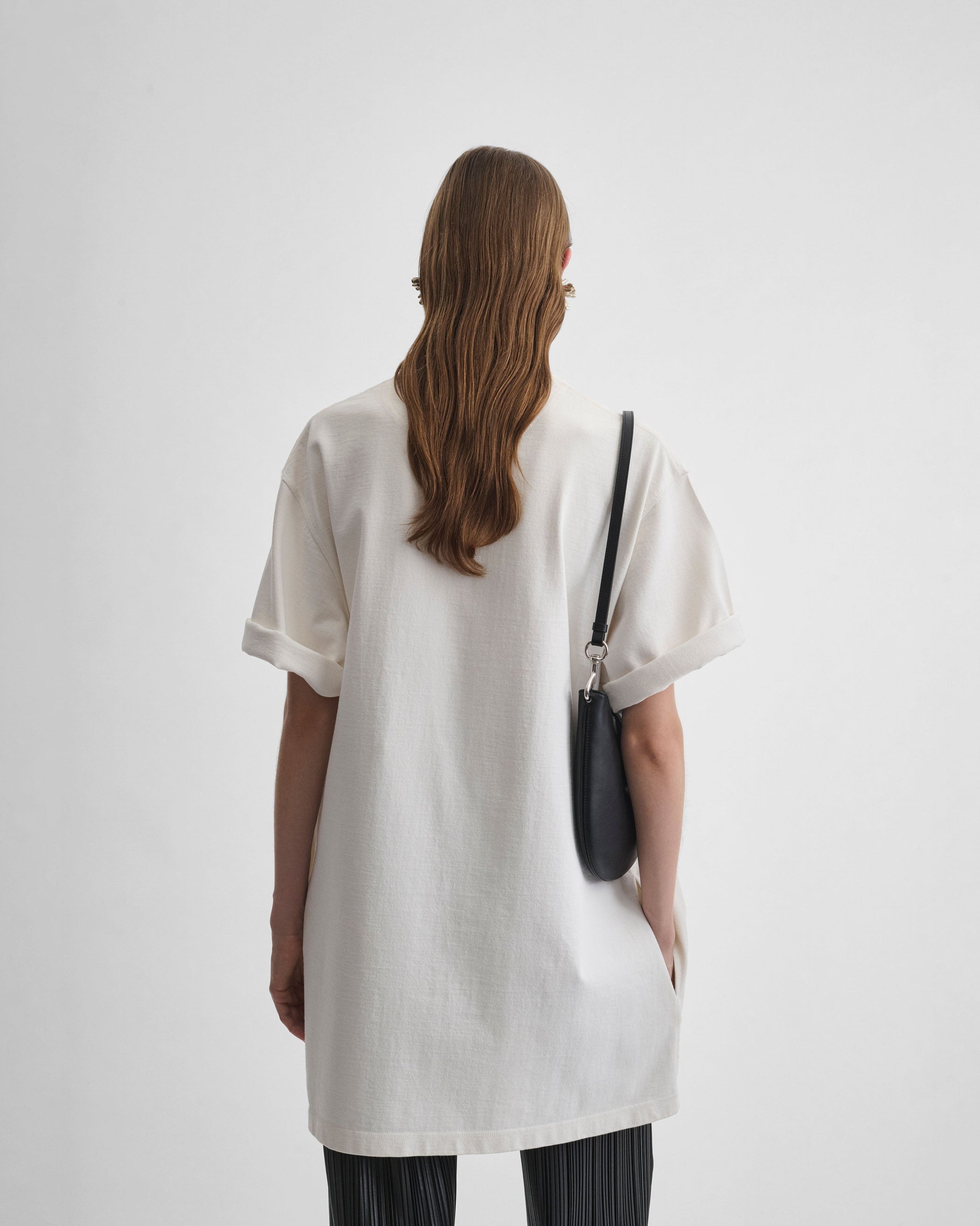 Back view of model wearing BIG T in white cotton