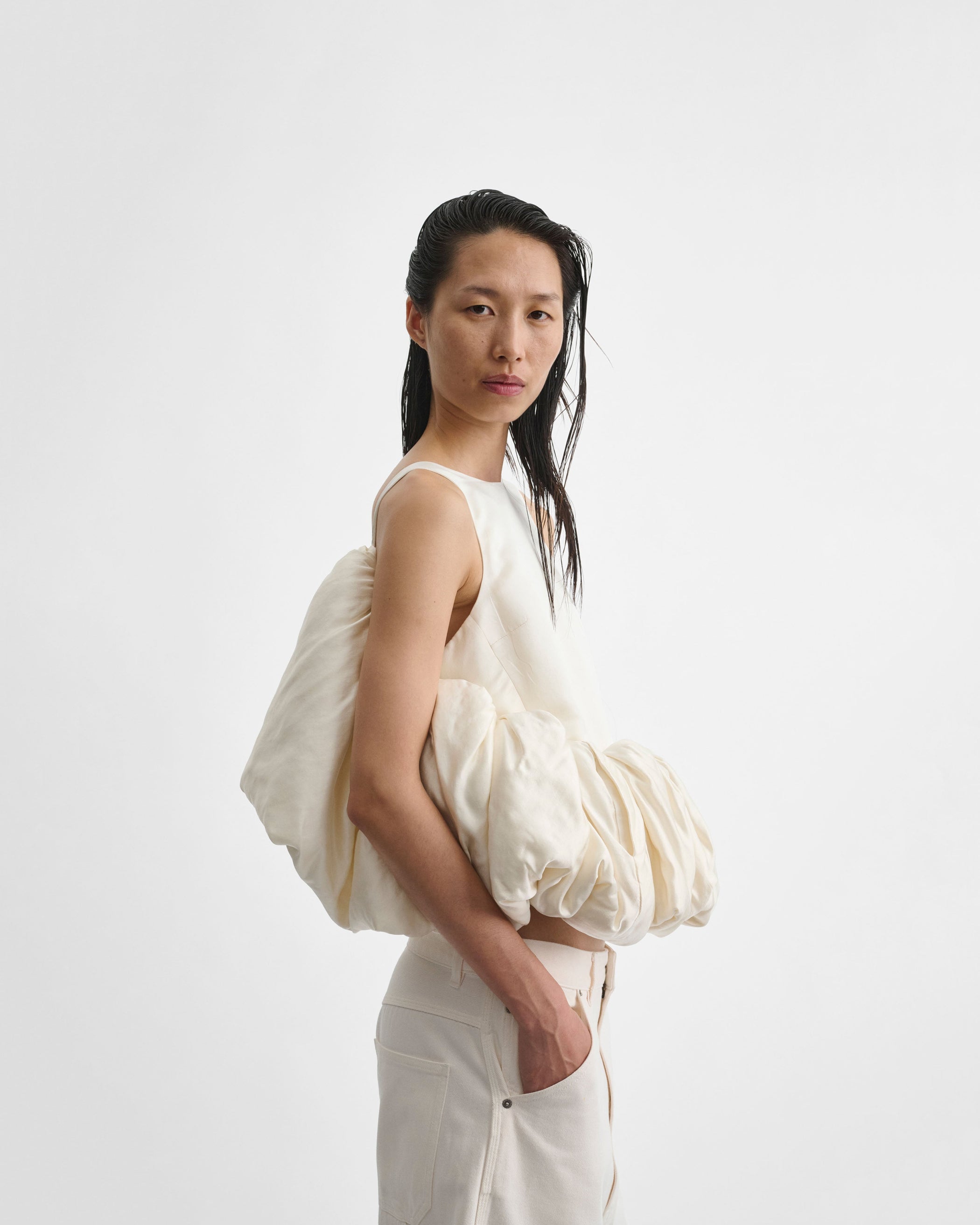 Side view of model wearing SUGAR VEST in vanilla silk satin